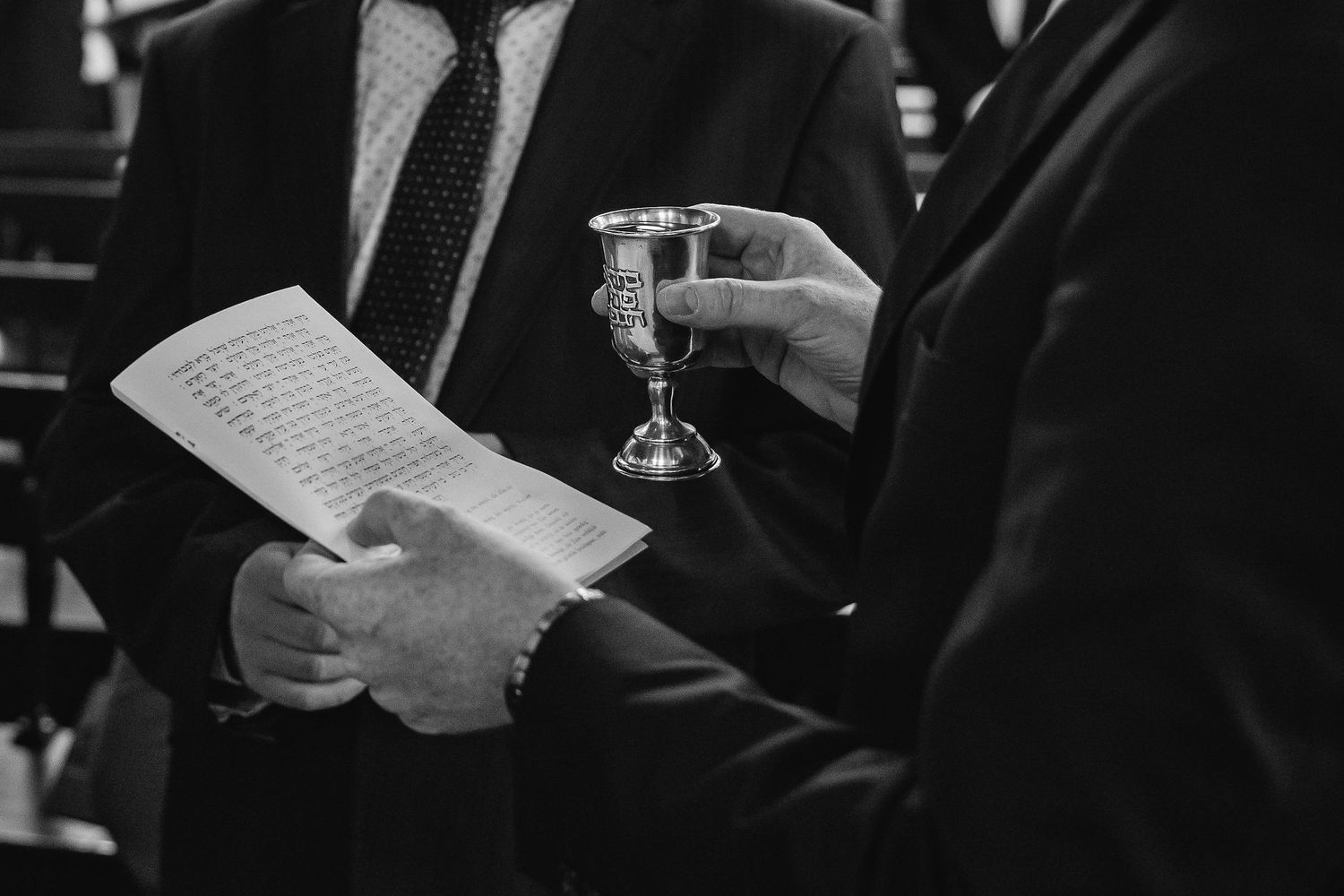 Dark atmospheric shots of guests holding papers at a formal event.