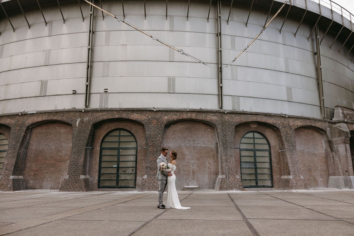 A sequence of wedding photos showing exterior views of a historic brick building venue.