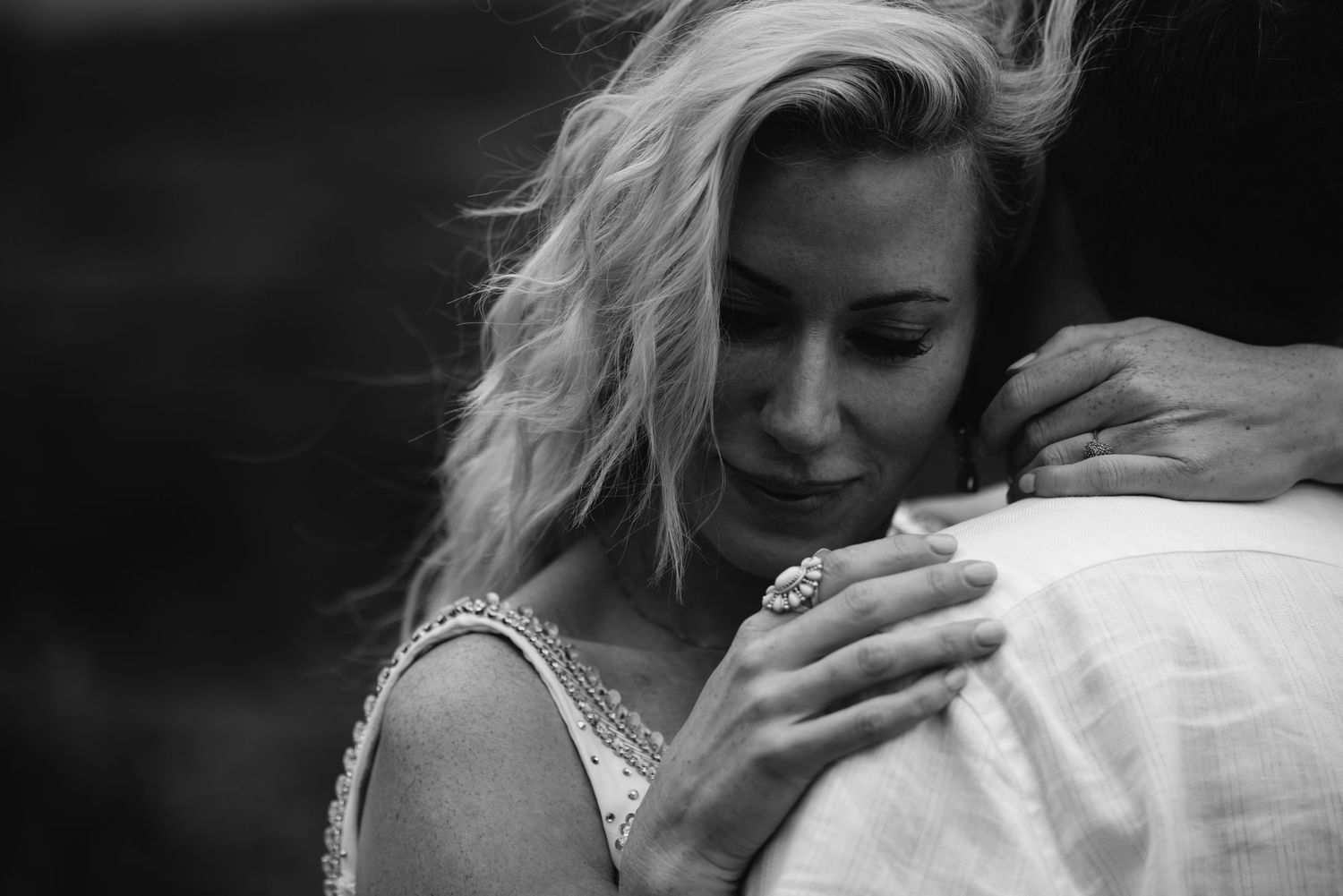 Black and white portrait of couple sharing intimate embrace.