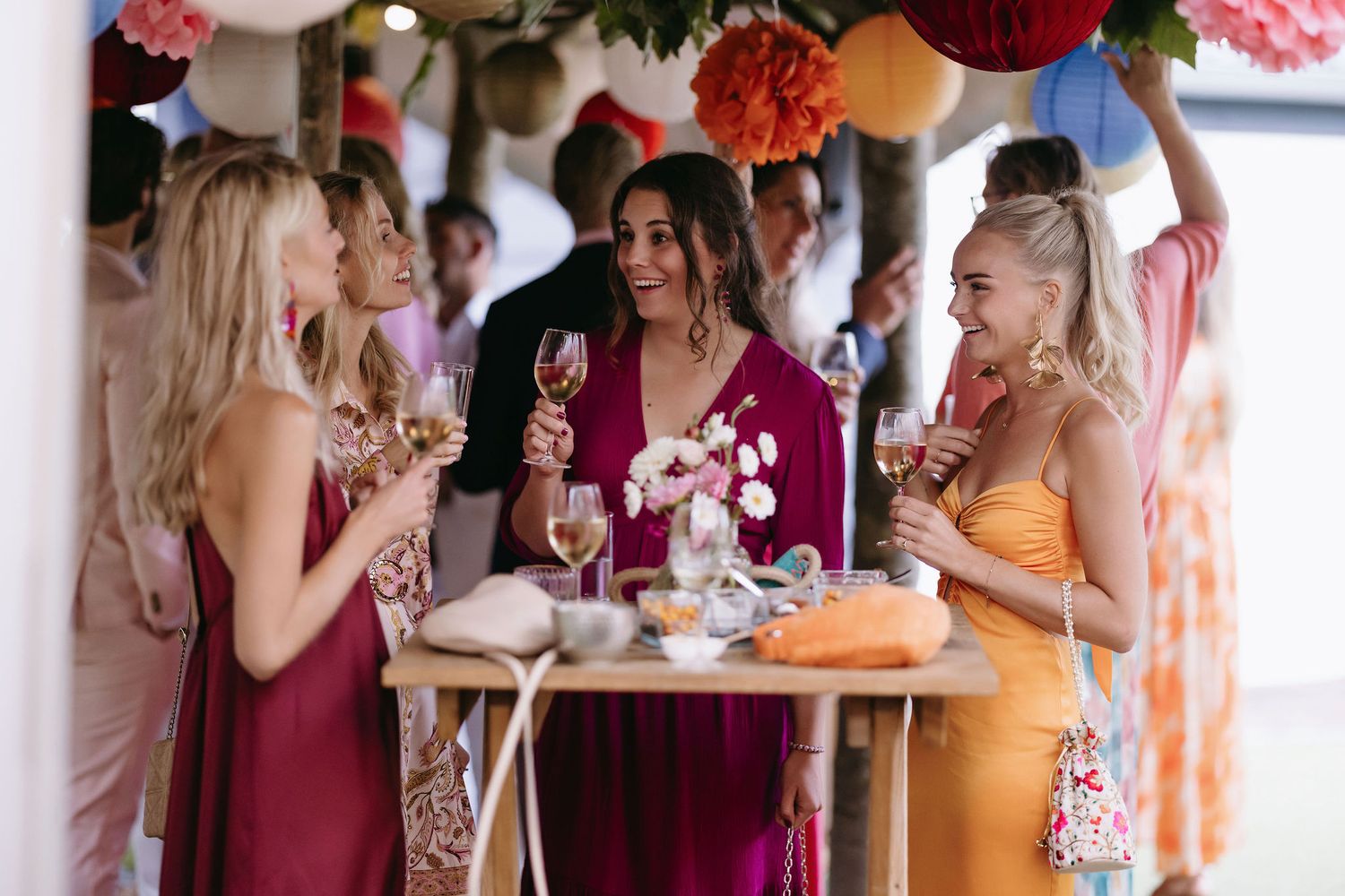 Group enjoying champagne and snacks at an elegantly decorated party.