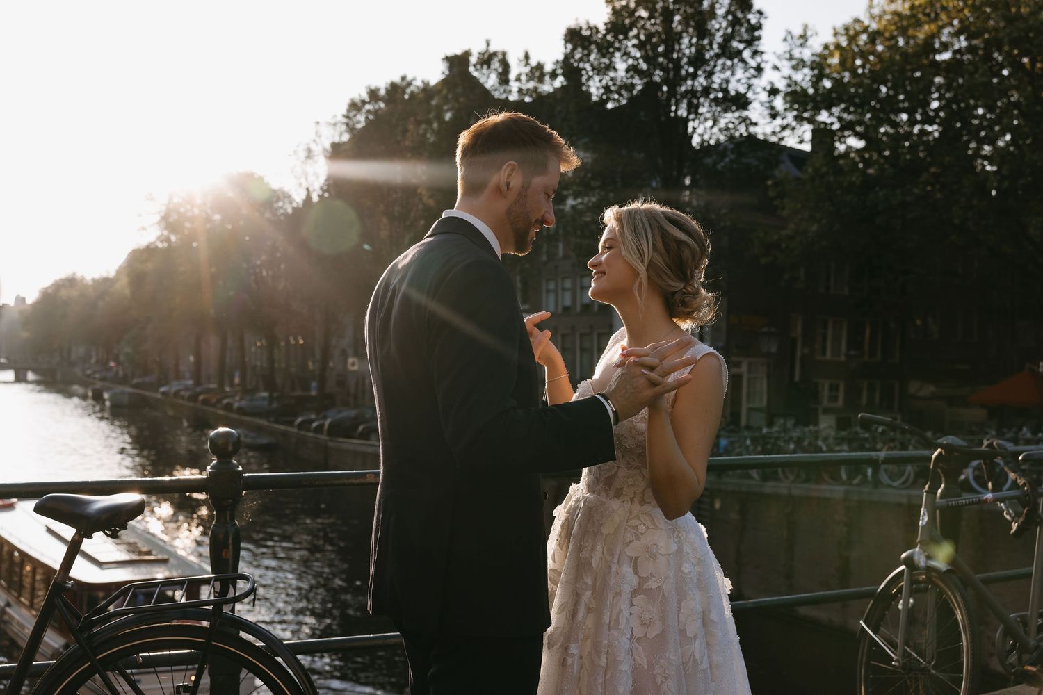 Romantic golden hour wedding portraits captured by the water at sunset.