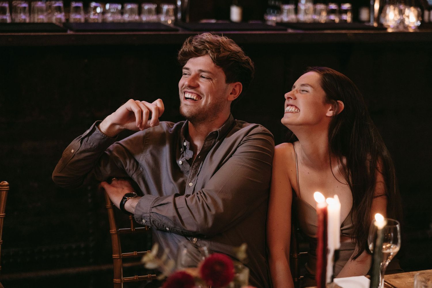 Wedding reception dinner scene with candlelit tables and romantic ambiance.