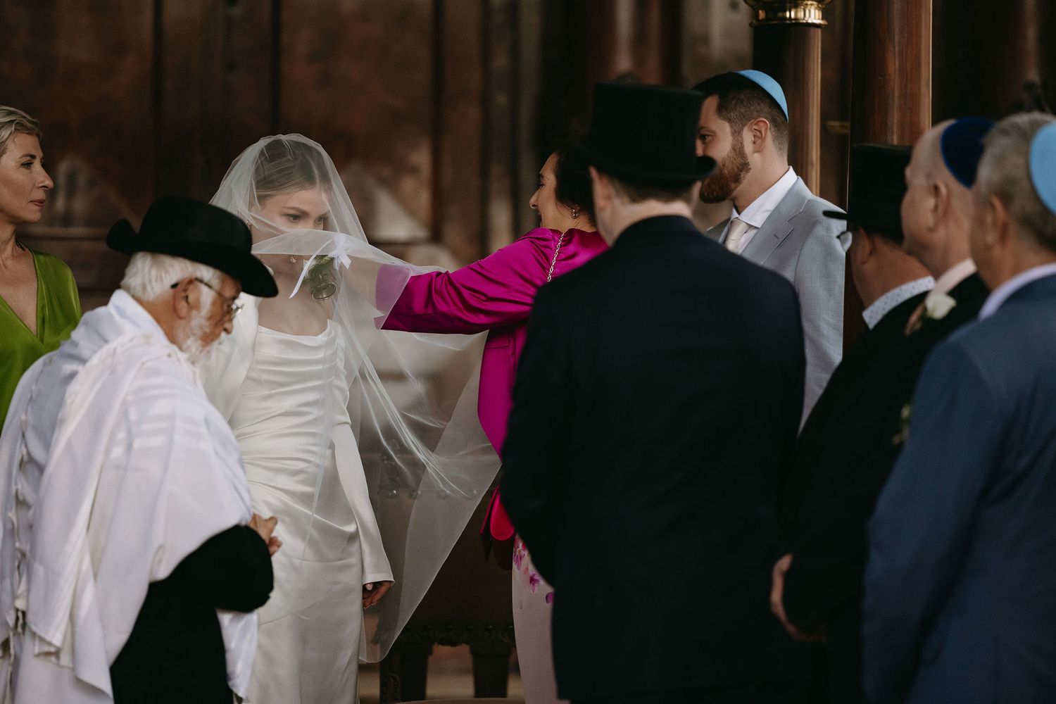 Wedding celebration with guests dancing and mingling in formal attire.