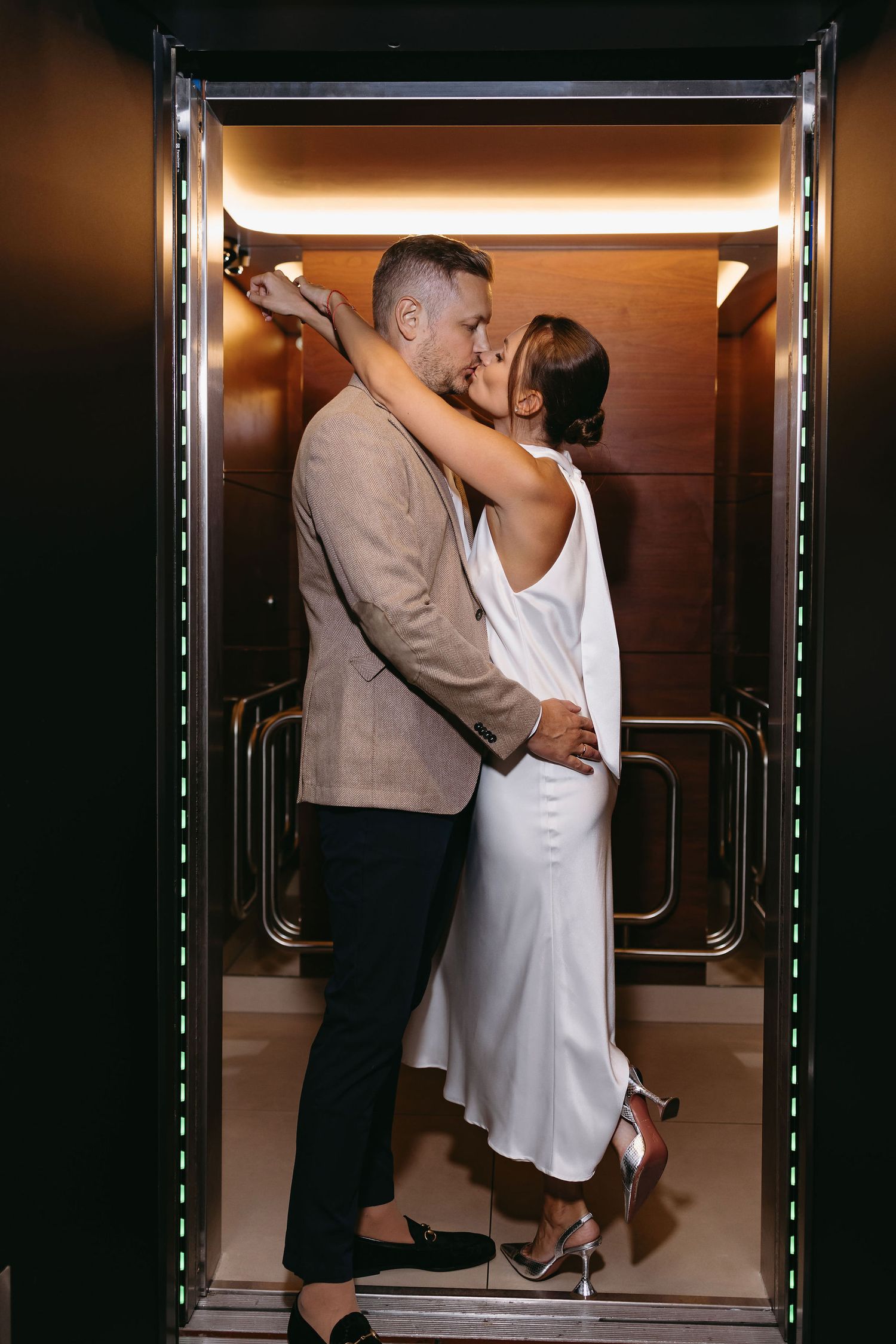 Intimate couple moments captured in sequence within a warmly lit elevator setting.