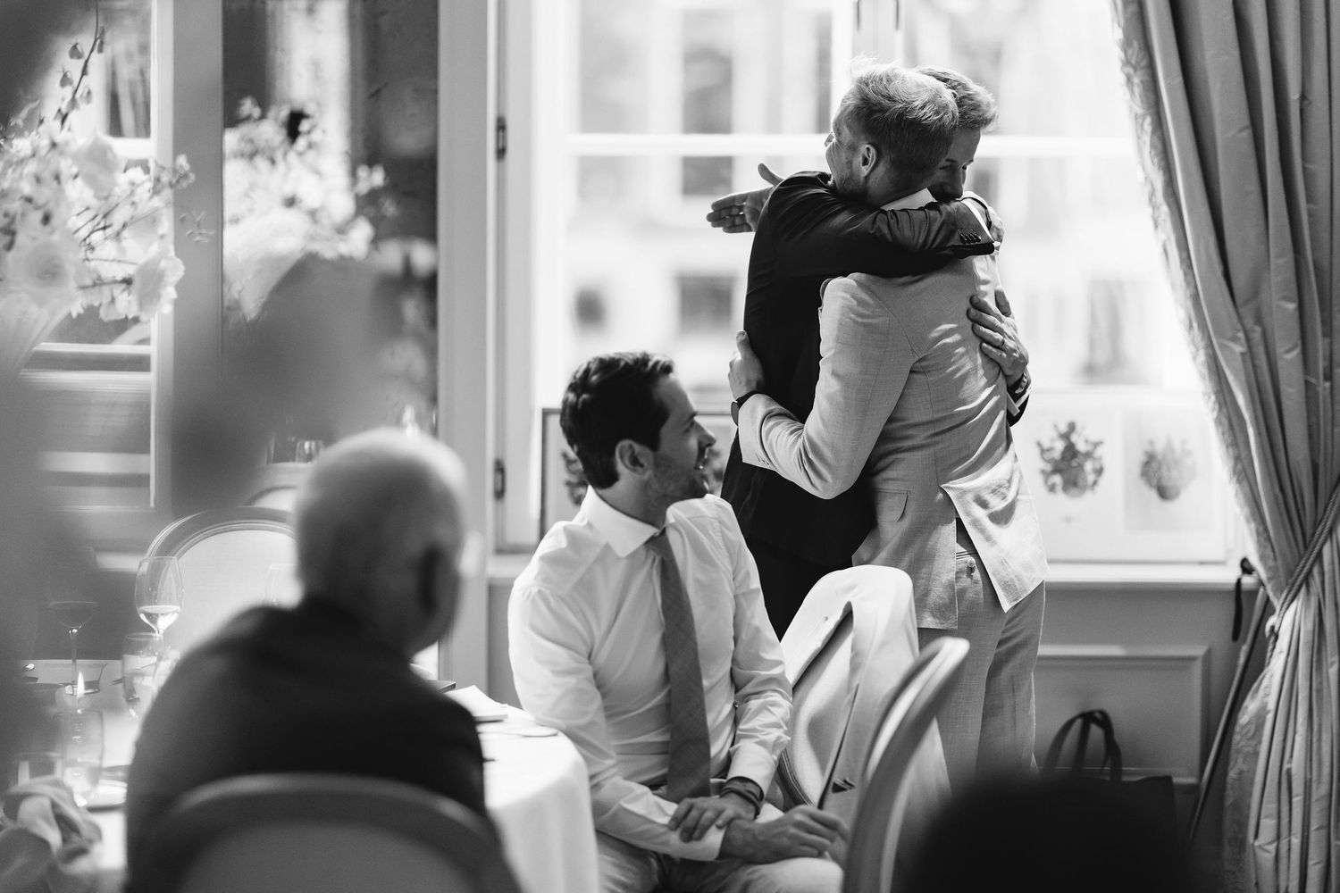 Emotional moment shared between wedding guests during reception celebration.