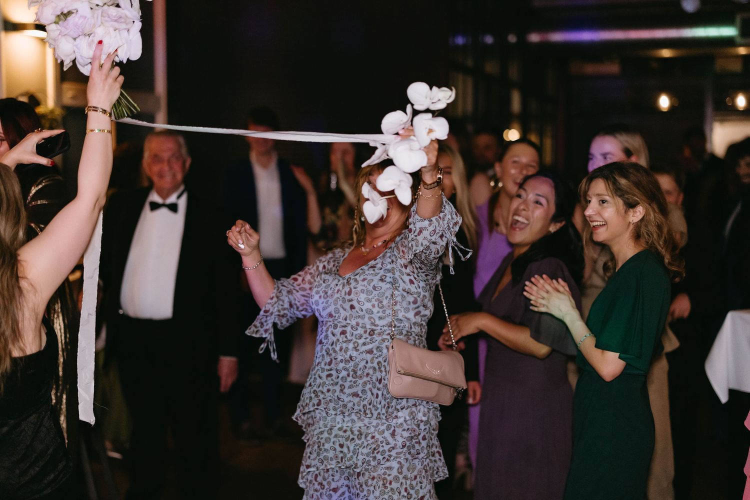 Wedding celebration with people dancing and enjoying the party.