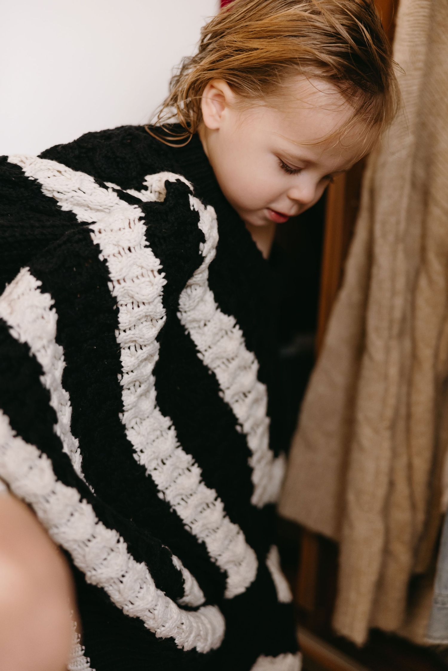 Black and white striped garment detail shot showing textured pattern and fabric.