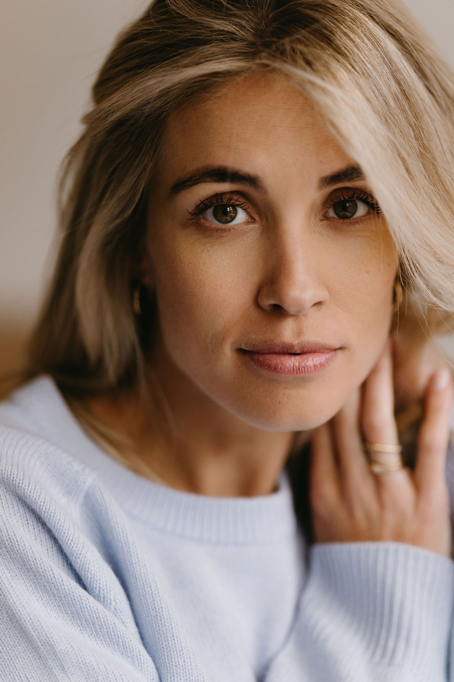 Close up portrait wearing cozy white sweater with natural lighting.