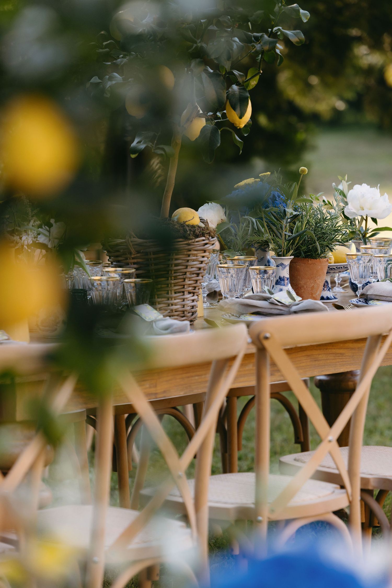 Rustic outdoor wedding table setting with woven baskets and garden-inspired decor.