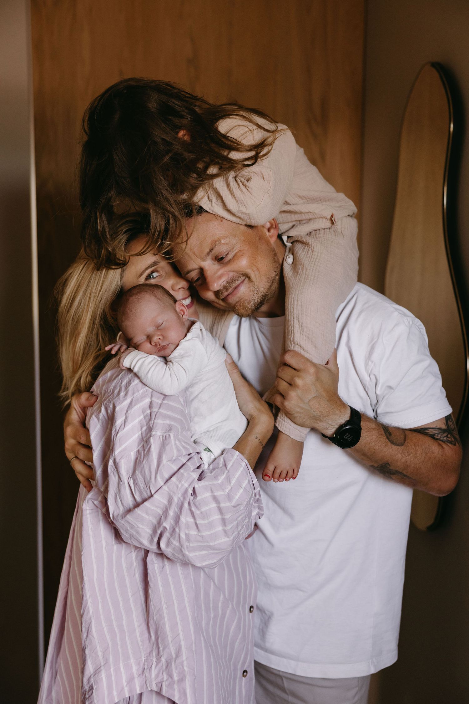 Tender family moment with baby captured in warm natural lighting.