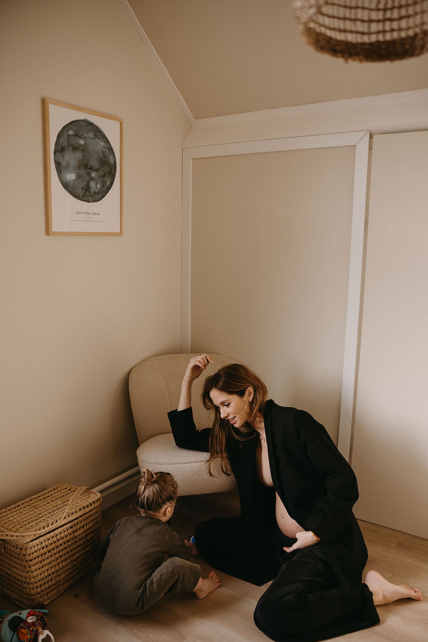 A cozy corner scene with moon artwork showing interaction on a beige chair.