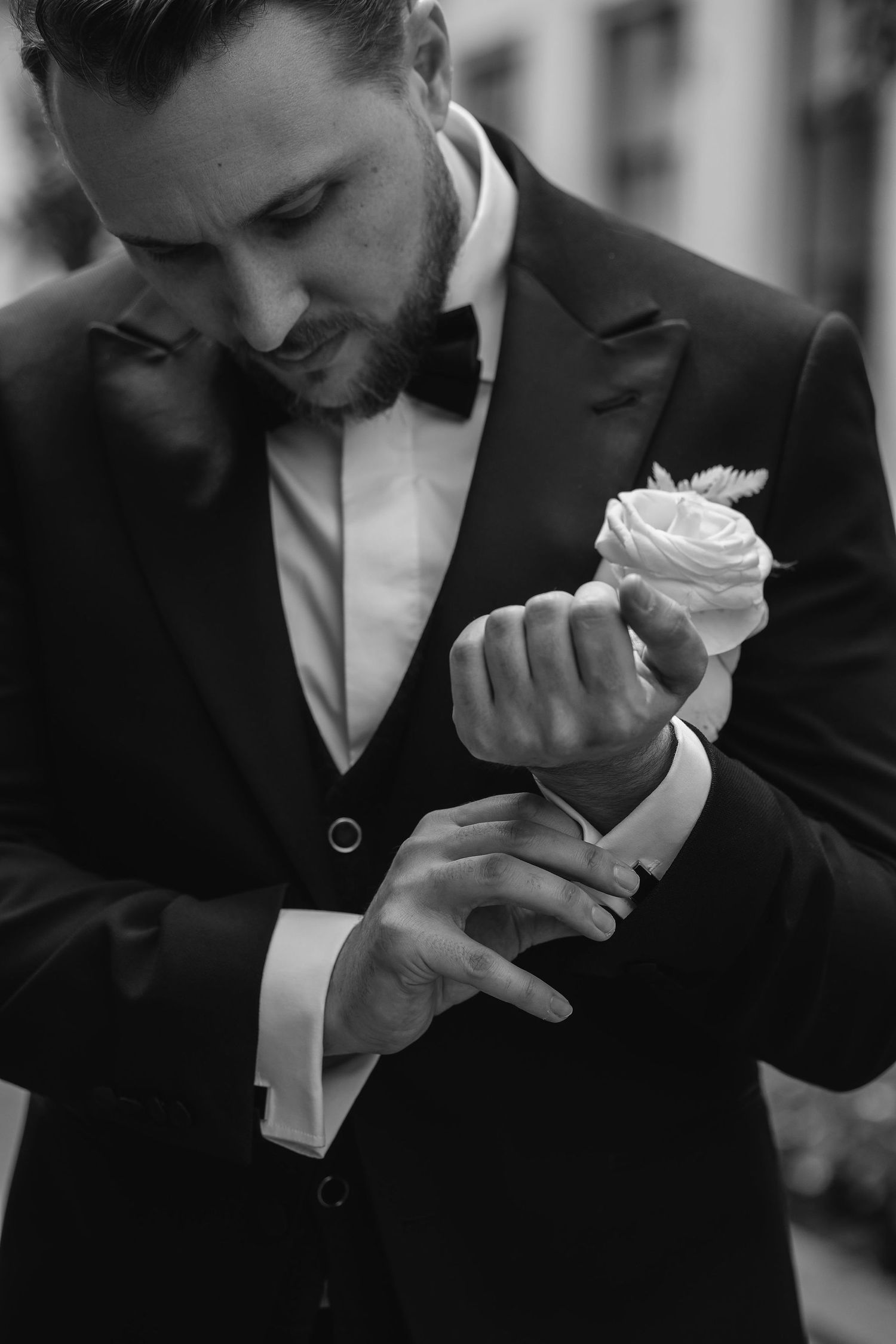 Emotions captured in black and white as someone holds a white rose.