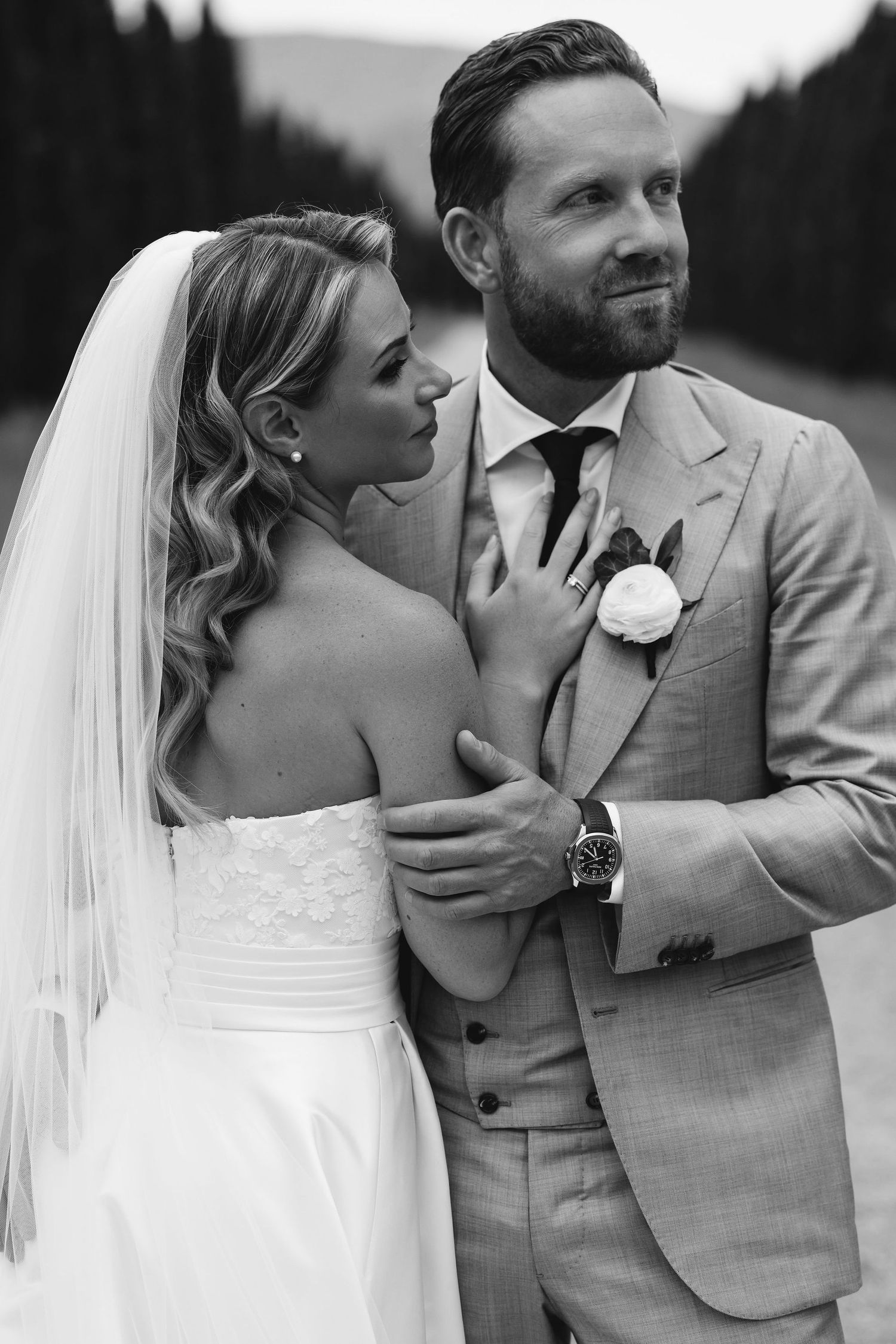Elegant wedding portrait in black and white against a mountain backdrop.