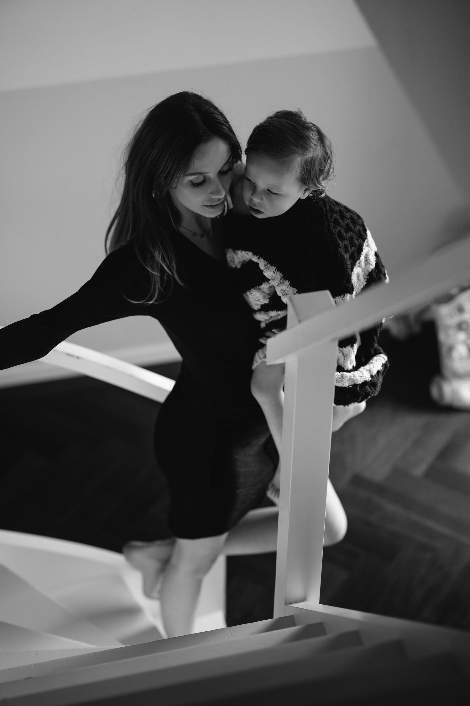 Black and white artistic sequence showing tender moments on stairs.