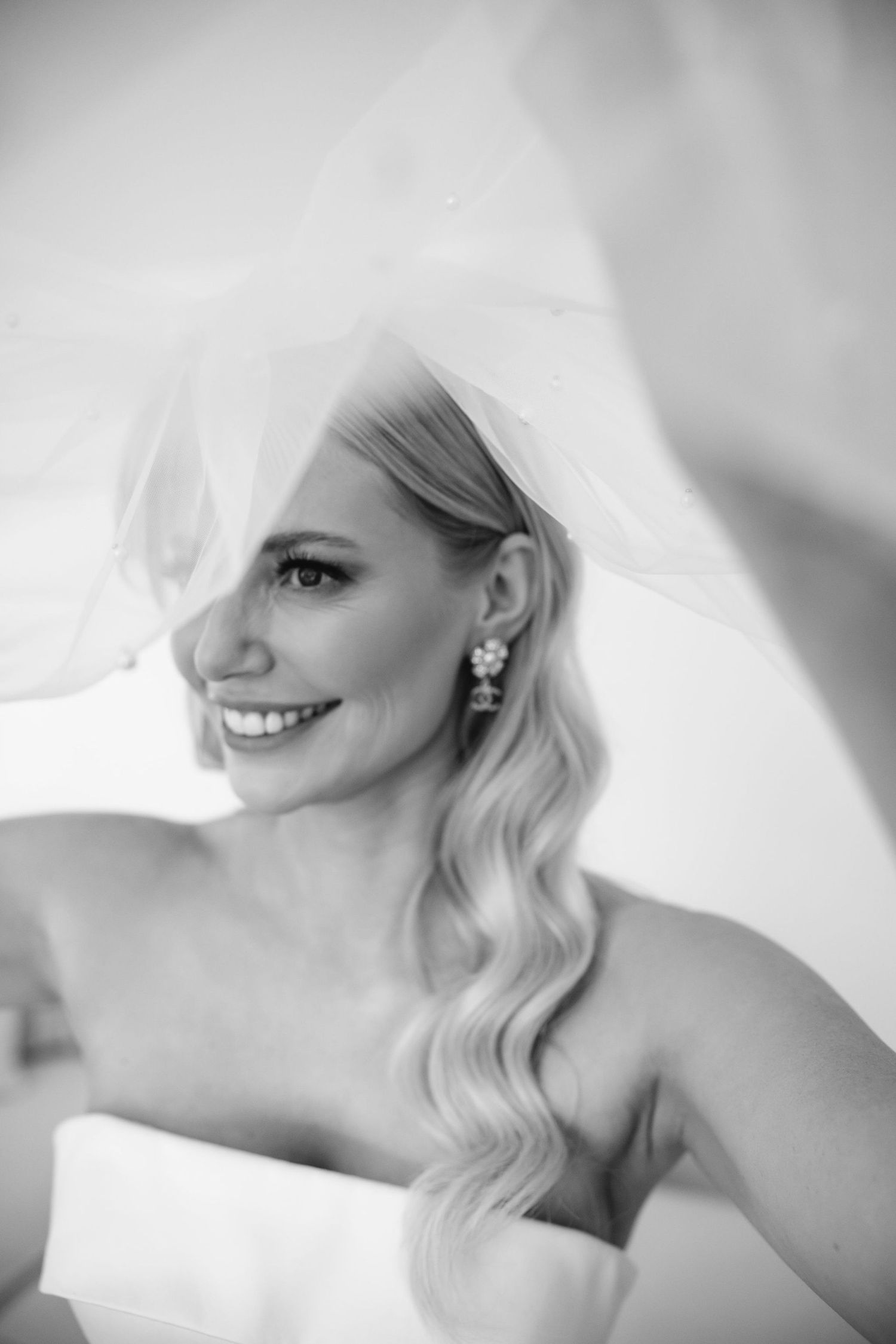 Ethereal black and white close-up portrait showing soft romantic details against a light background.