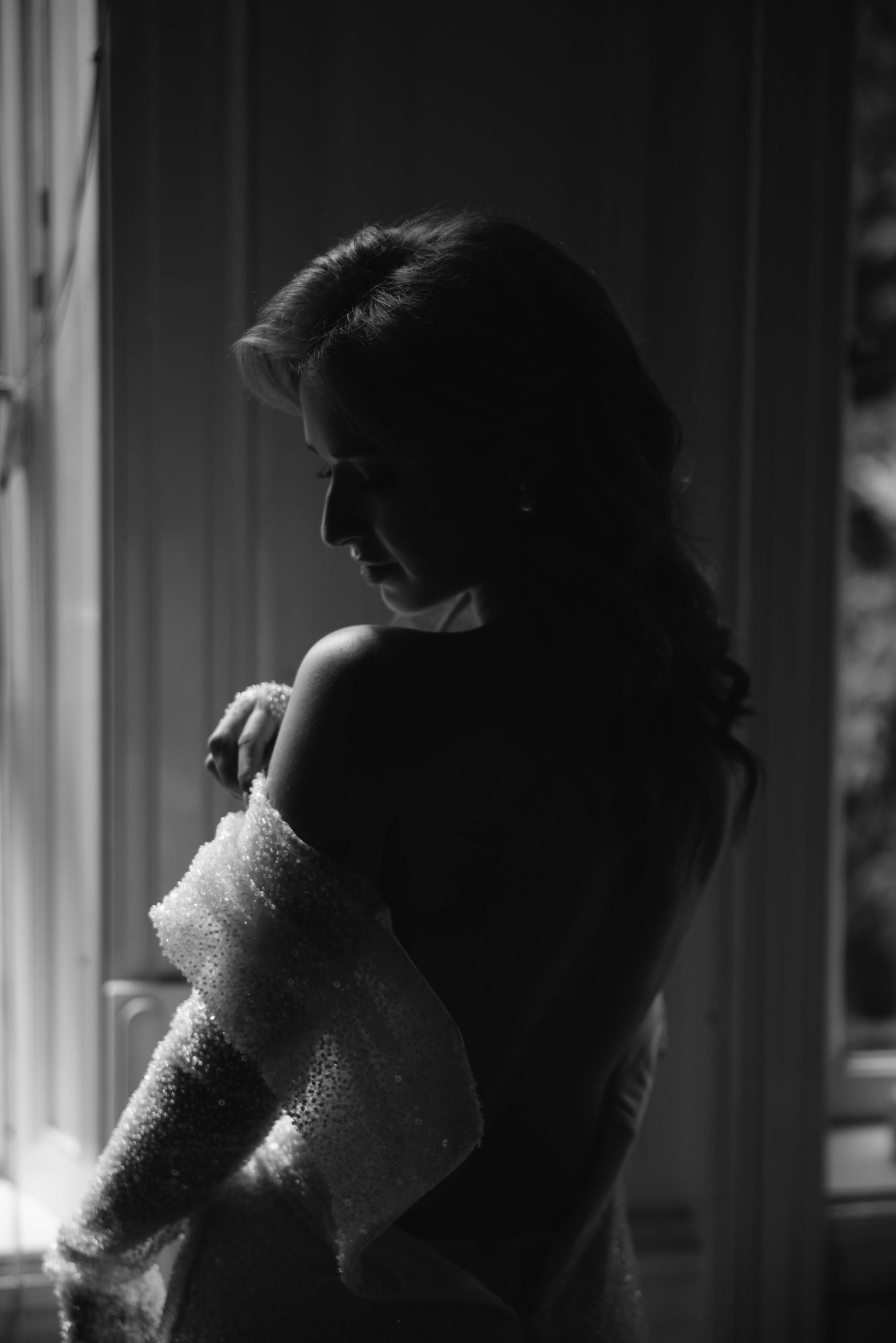 Atmospheric black and white portrait sequence showing emotional artistic poses in dramatic lighting.