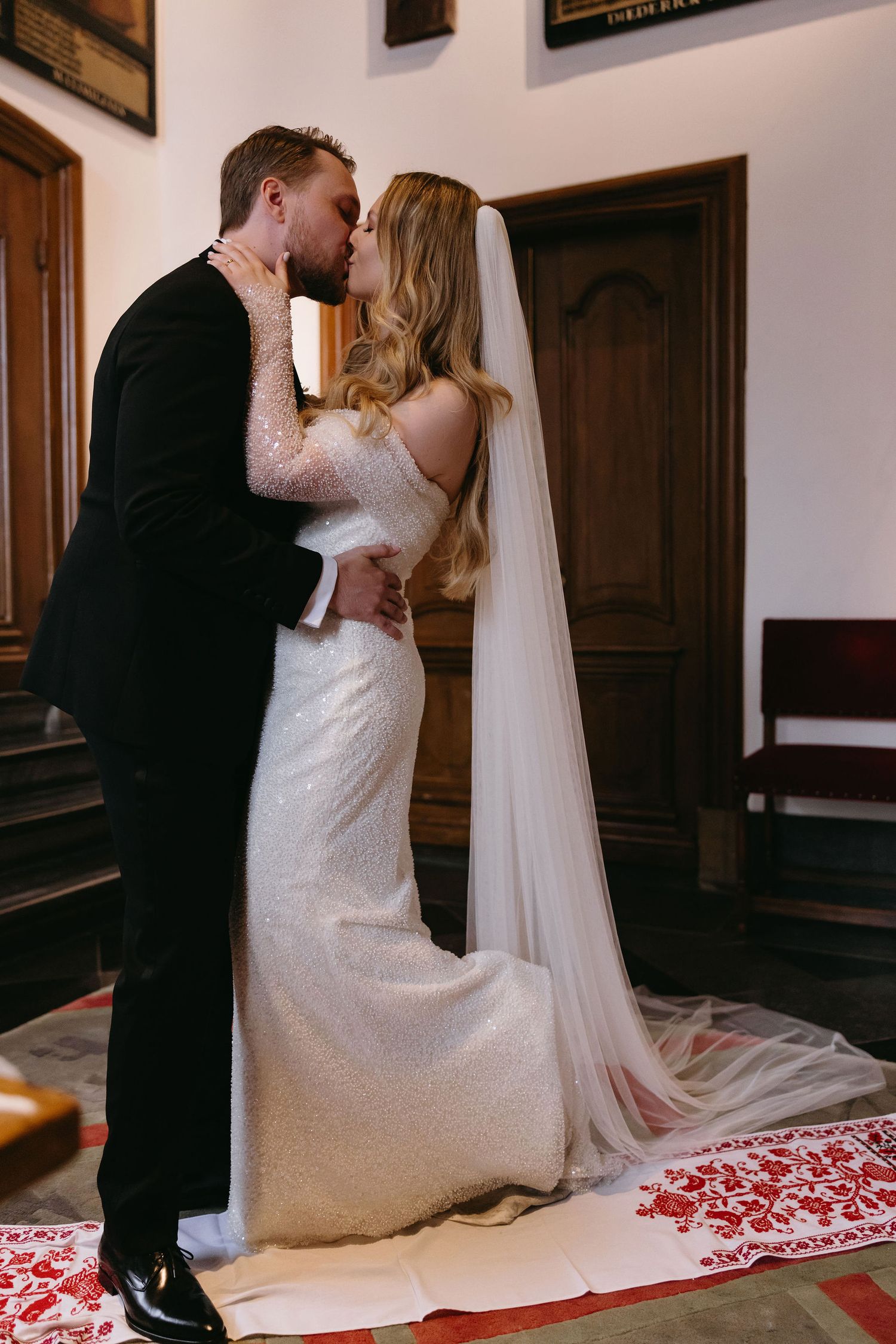 Wedding couple sharing an intimate moment in an elegant church setting.