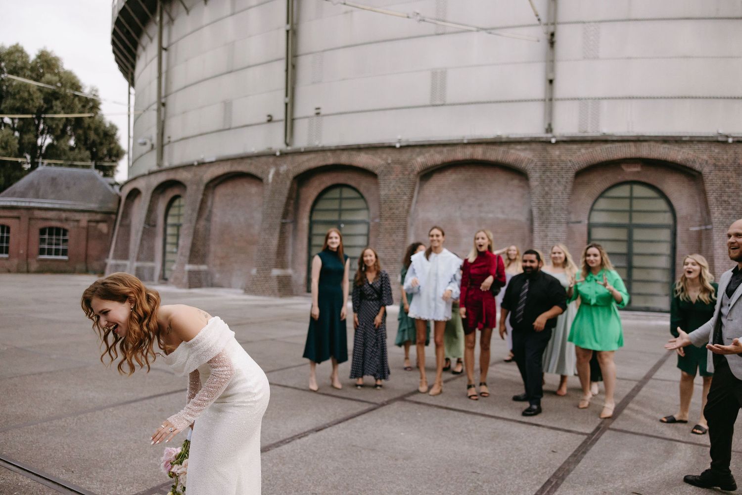 Candid moments captured outside a historic stone building during wedding festivities.