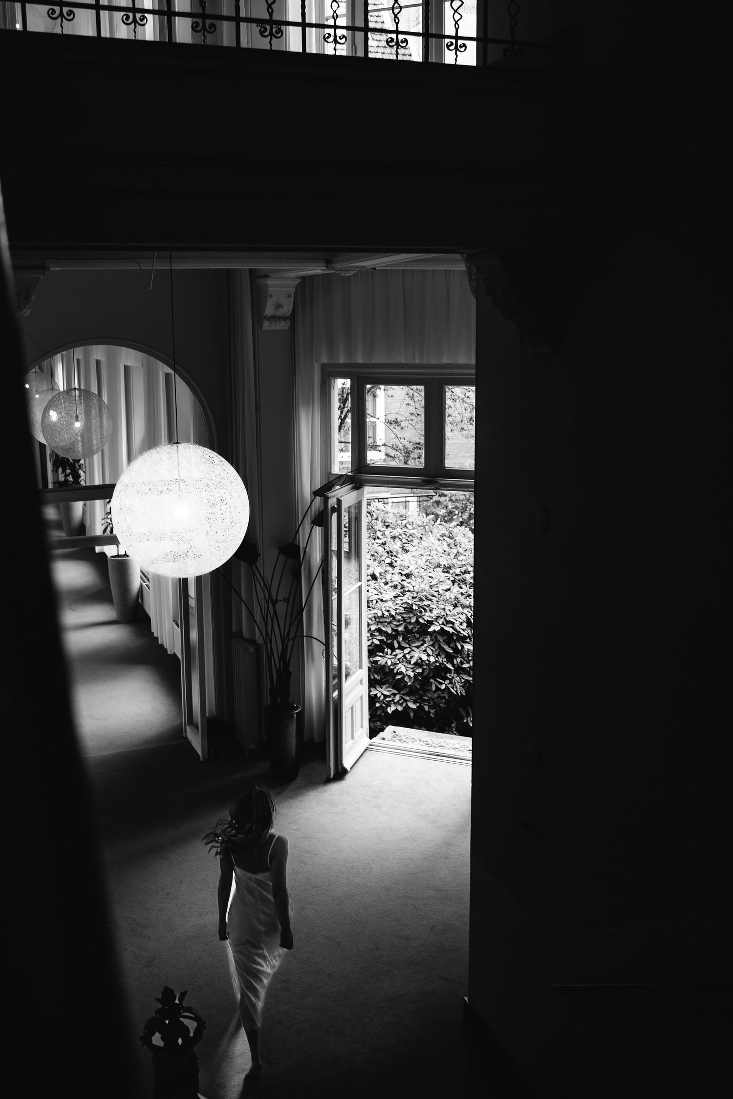 Dramatic black and white architectural shot of a hallway with natural light.