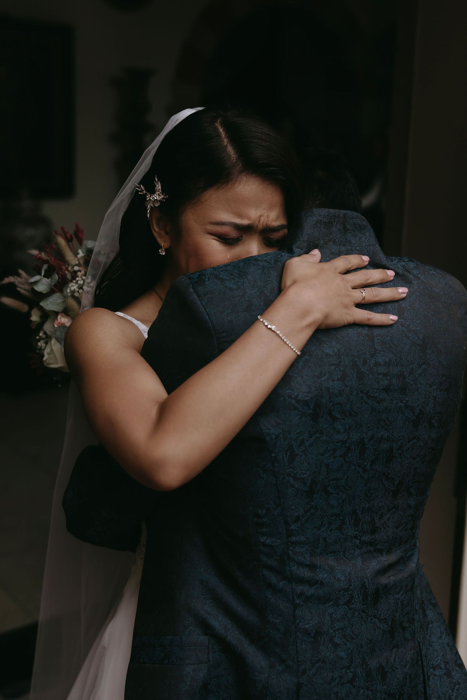 A series of close-up shots showing tender emotional moments between two people in dark formal attire.