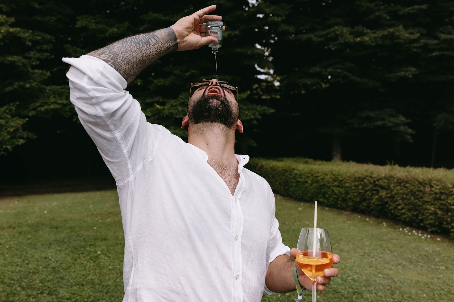 Wedding guests enjoying drinks and celebrations in an outdoor garden setting.