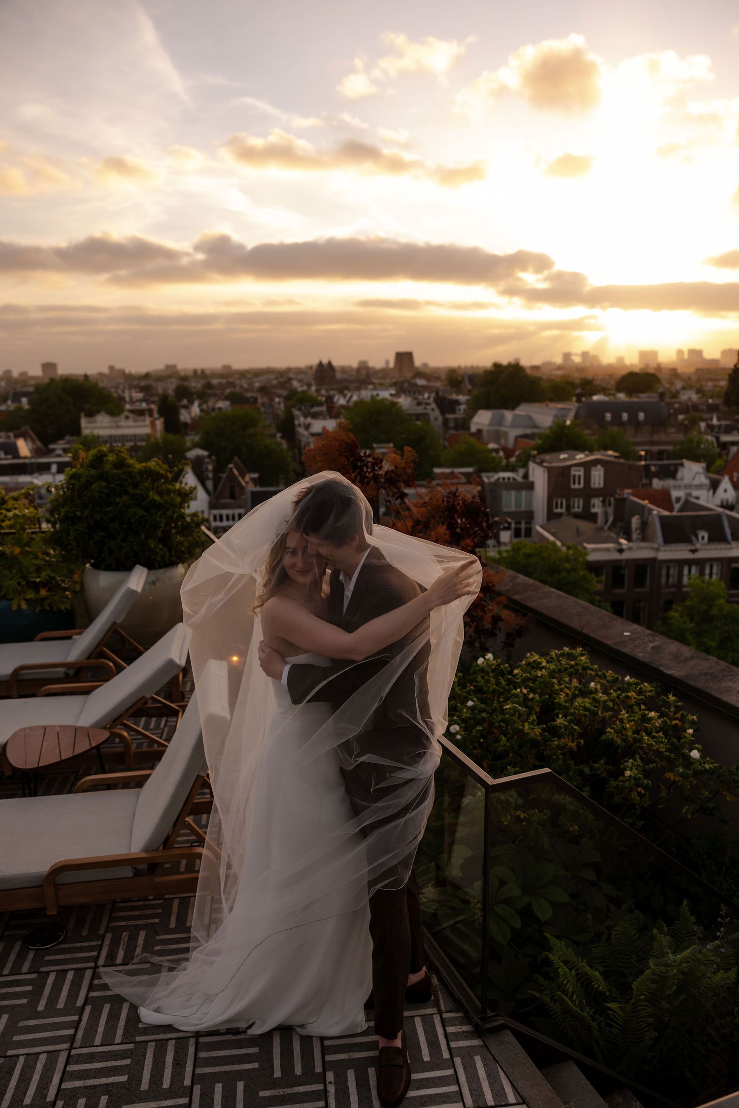 Romantic sunset wedding dance sequence on a rooftop terrace overlooking an urban cityscape.