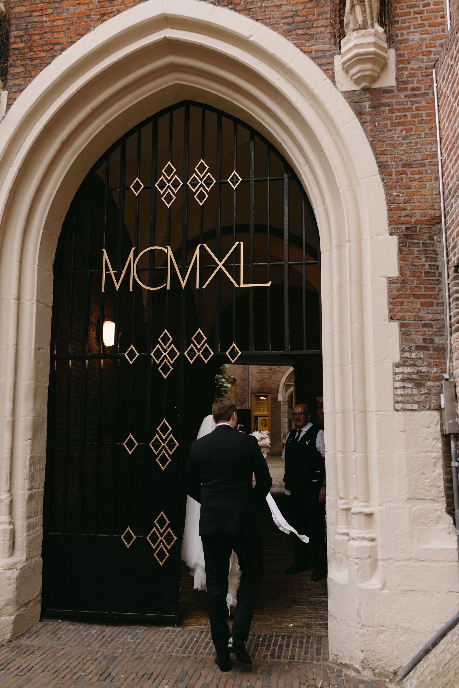 Art deco doorway entrance with MCMXL signage in gothic arch.