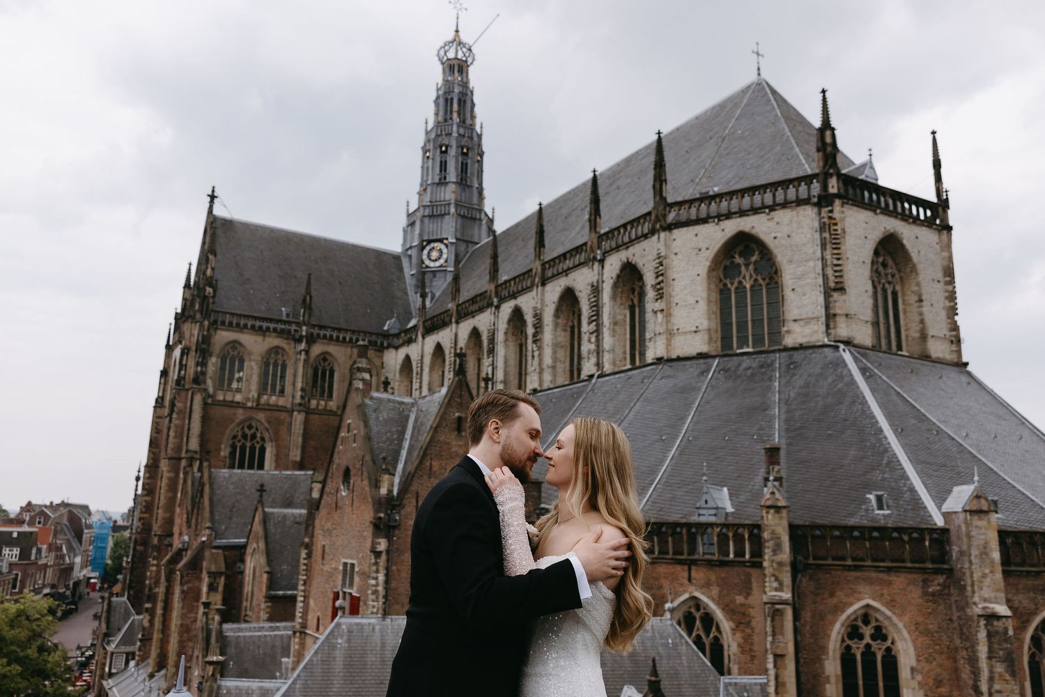 Romantic wedding portraits taken against the backdrop of a majestic Gothic church.