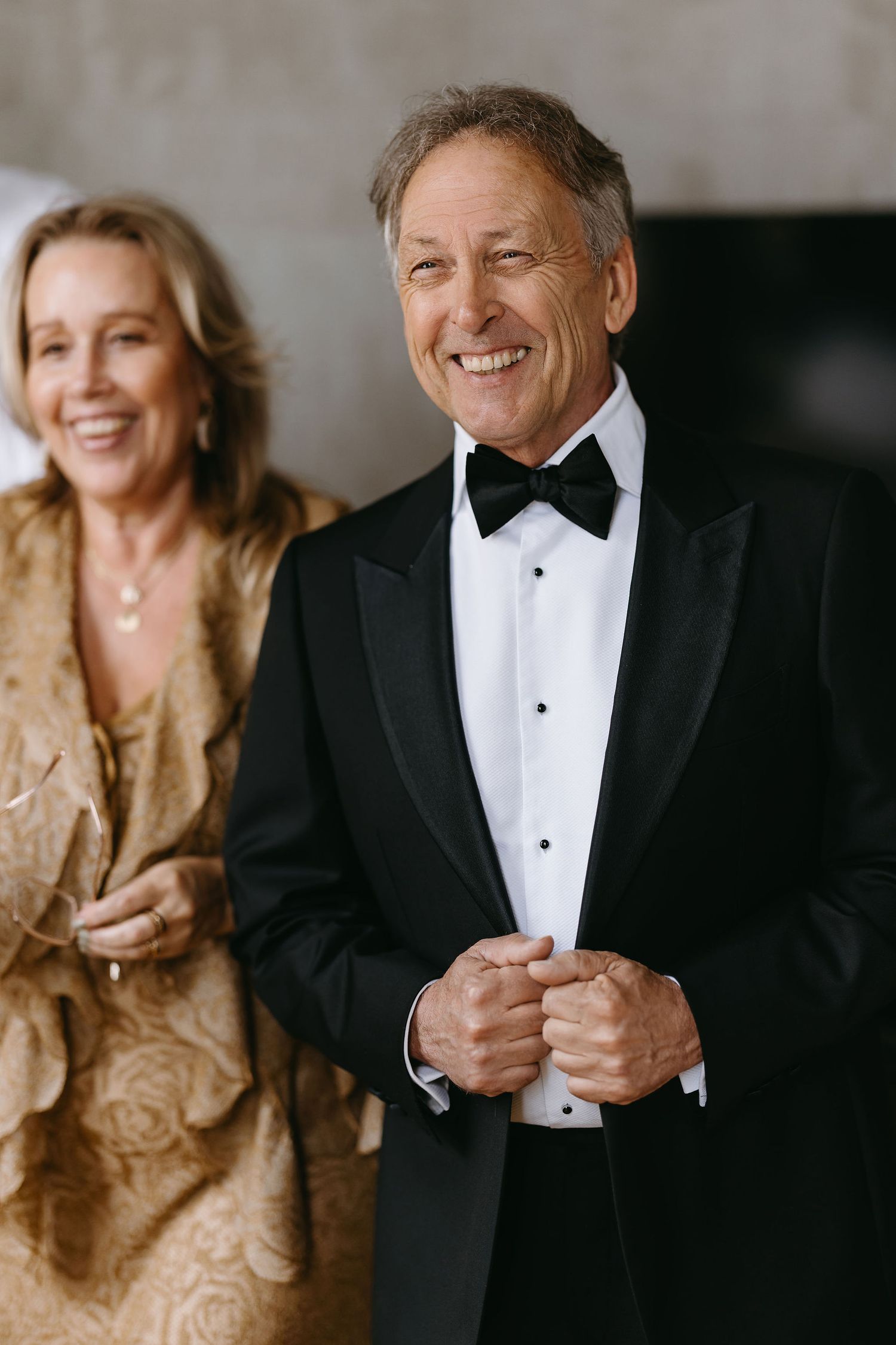 Formal couple in evening wear with man wearing classic black tuxedo and bowtie.