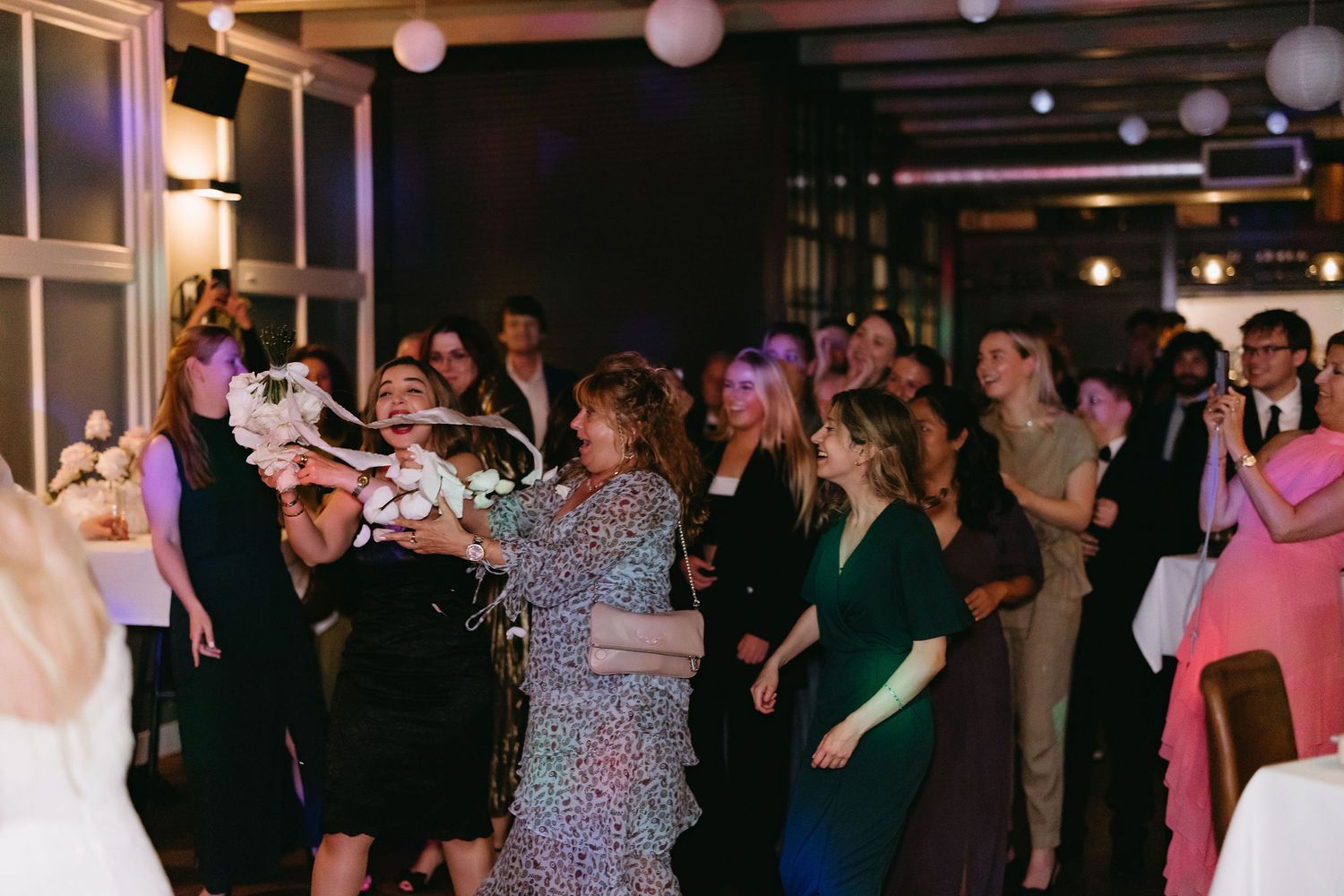 Wedding reception dance floor filled with guests enjoying the celebration.