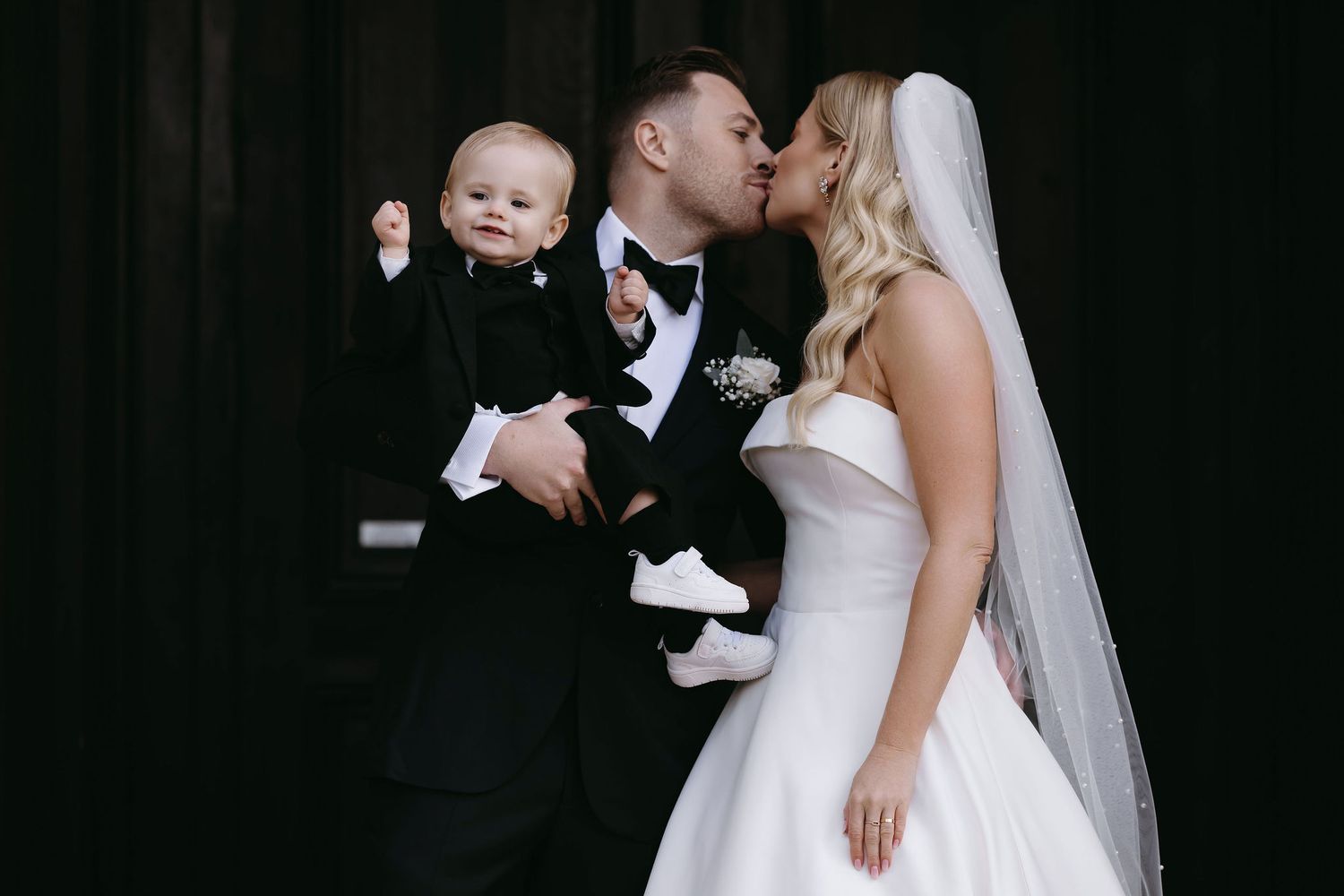 A wedding celebration moment captured in black and white with the bride in a flowing white gown.