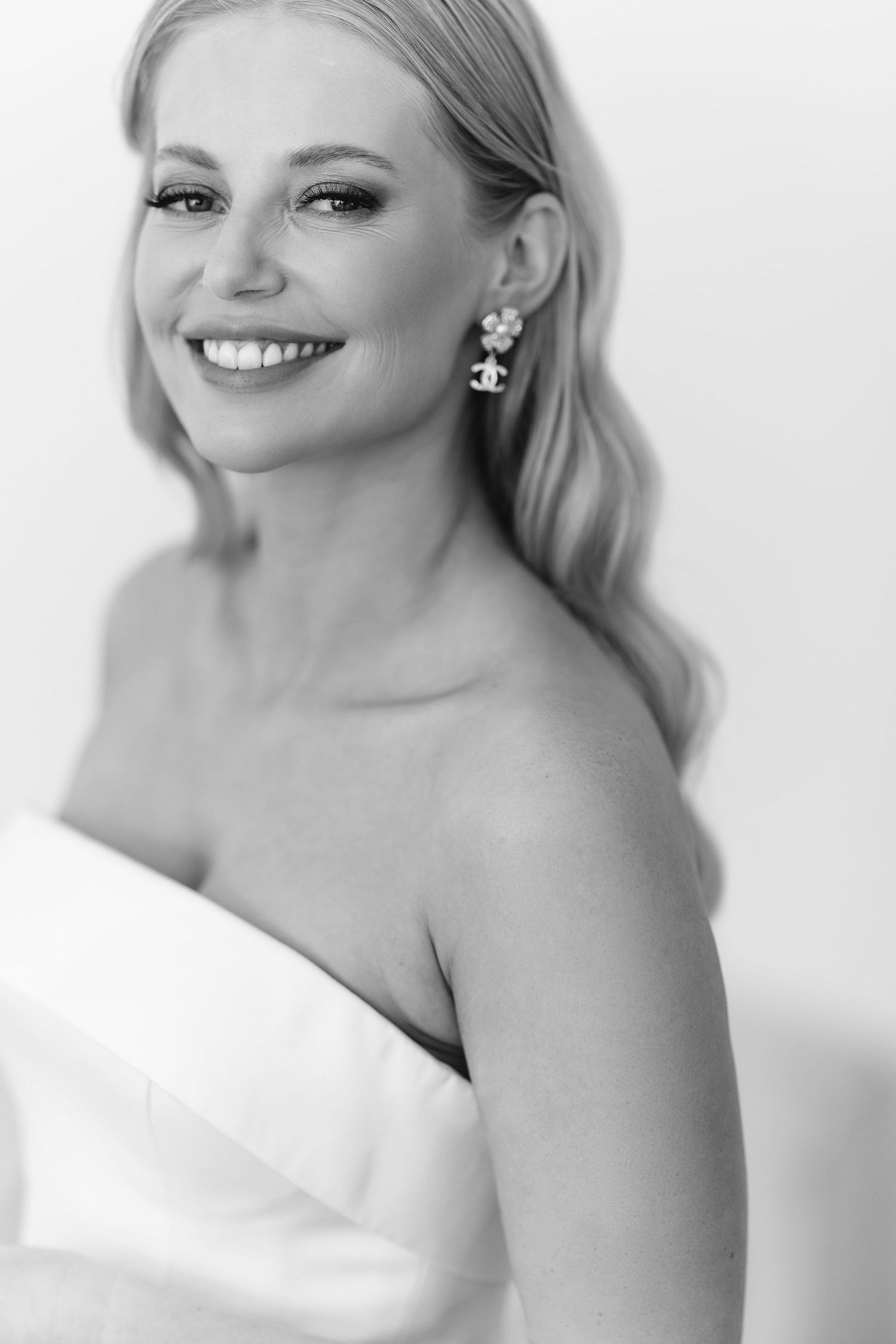 Black and white portrait in elegant strapless dress with classic jewelry.