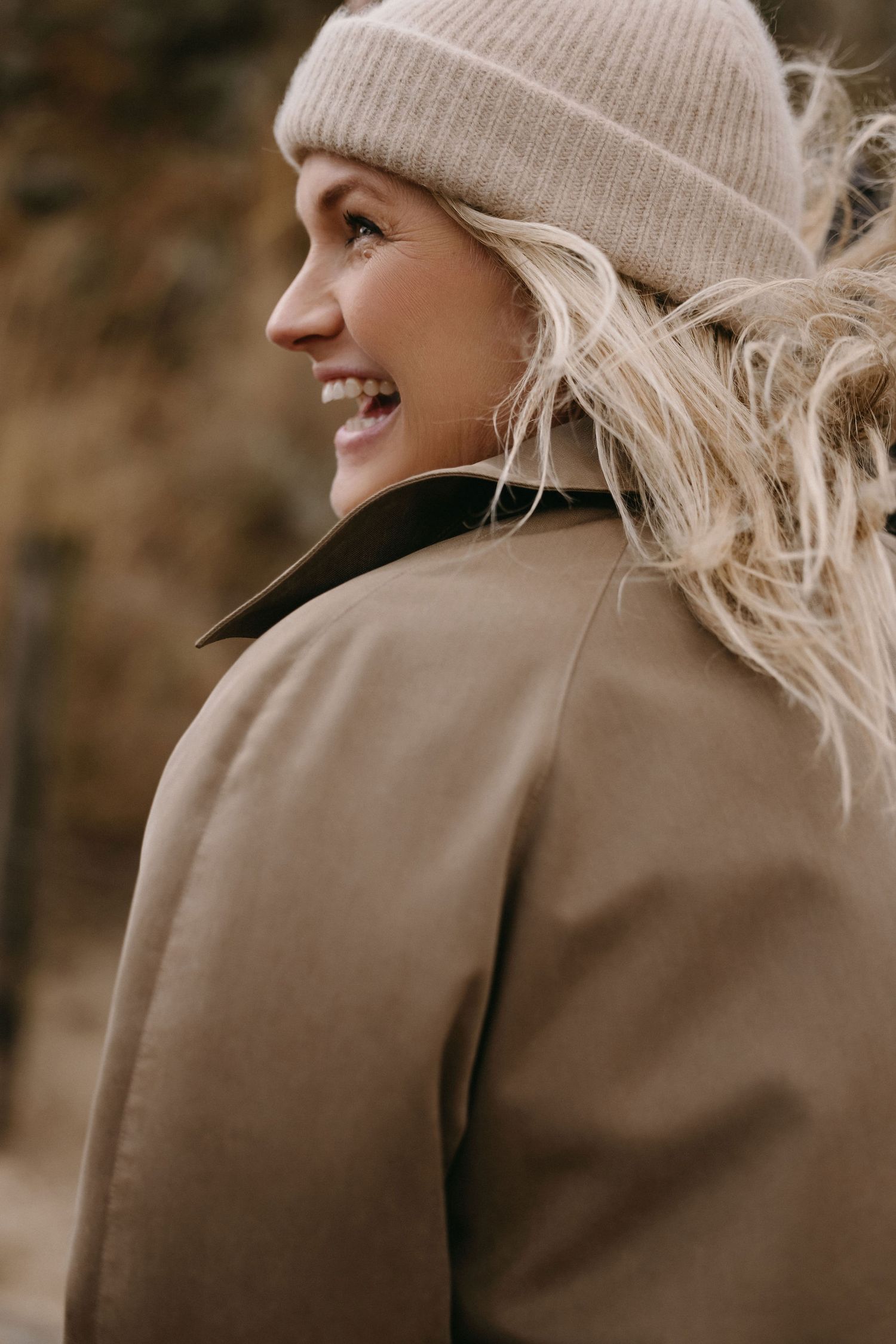 Gentle side profile portraits showing expressions of joy while wearing beige winter hat.