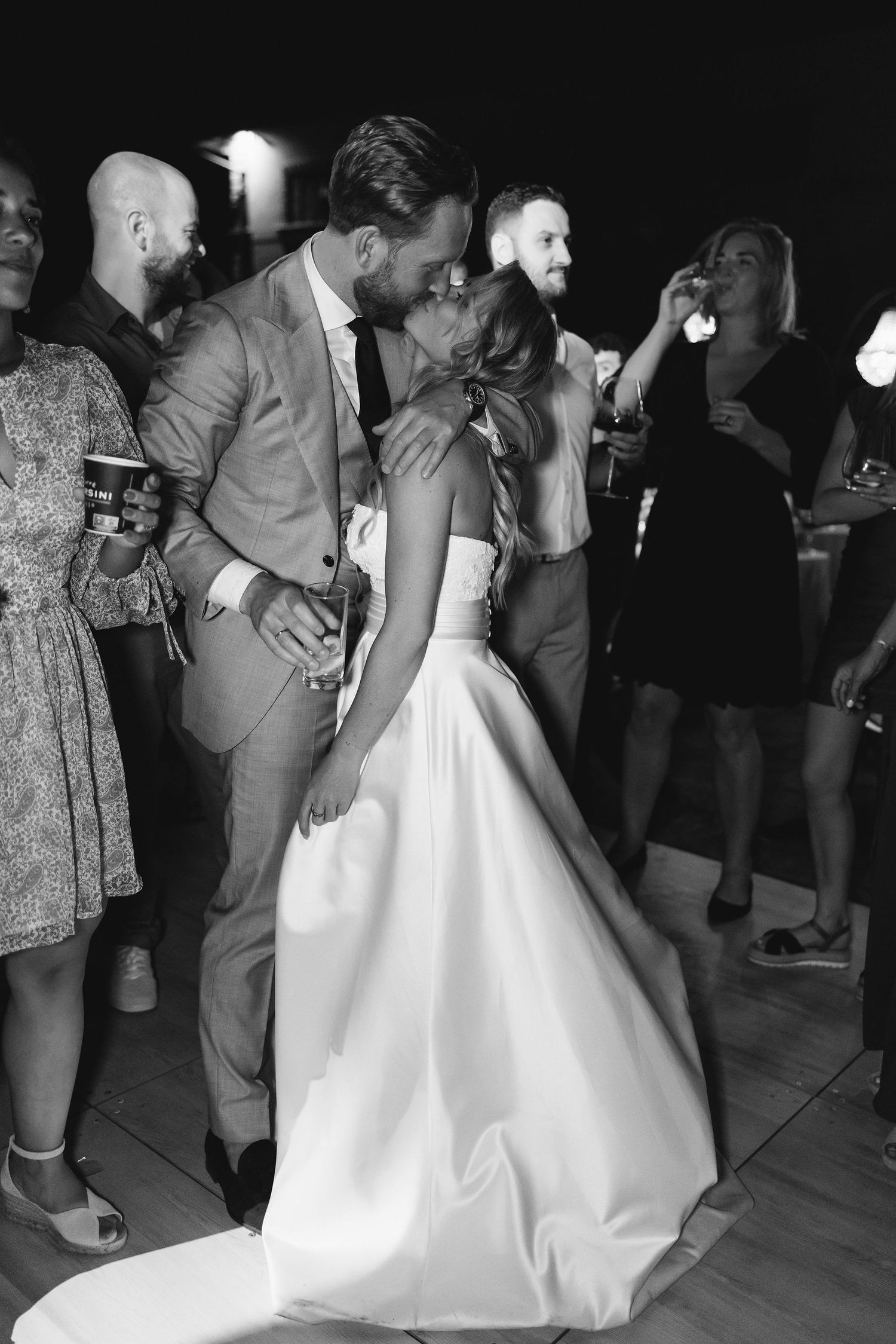 Black and white photo of newlyweds sharing an intimate dance moment at their reception.
