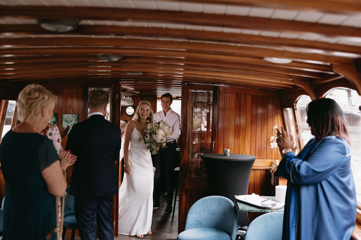 Interior shots of a wedding reception space showing guests mingling in an elegant venue.