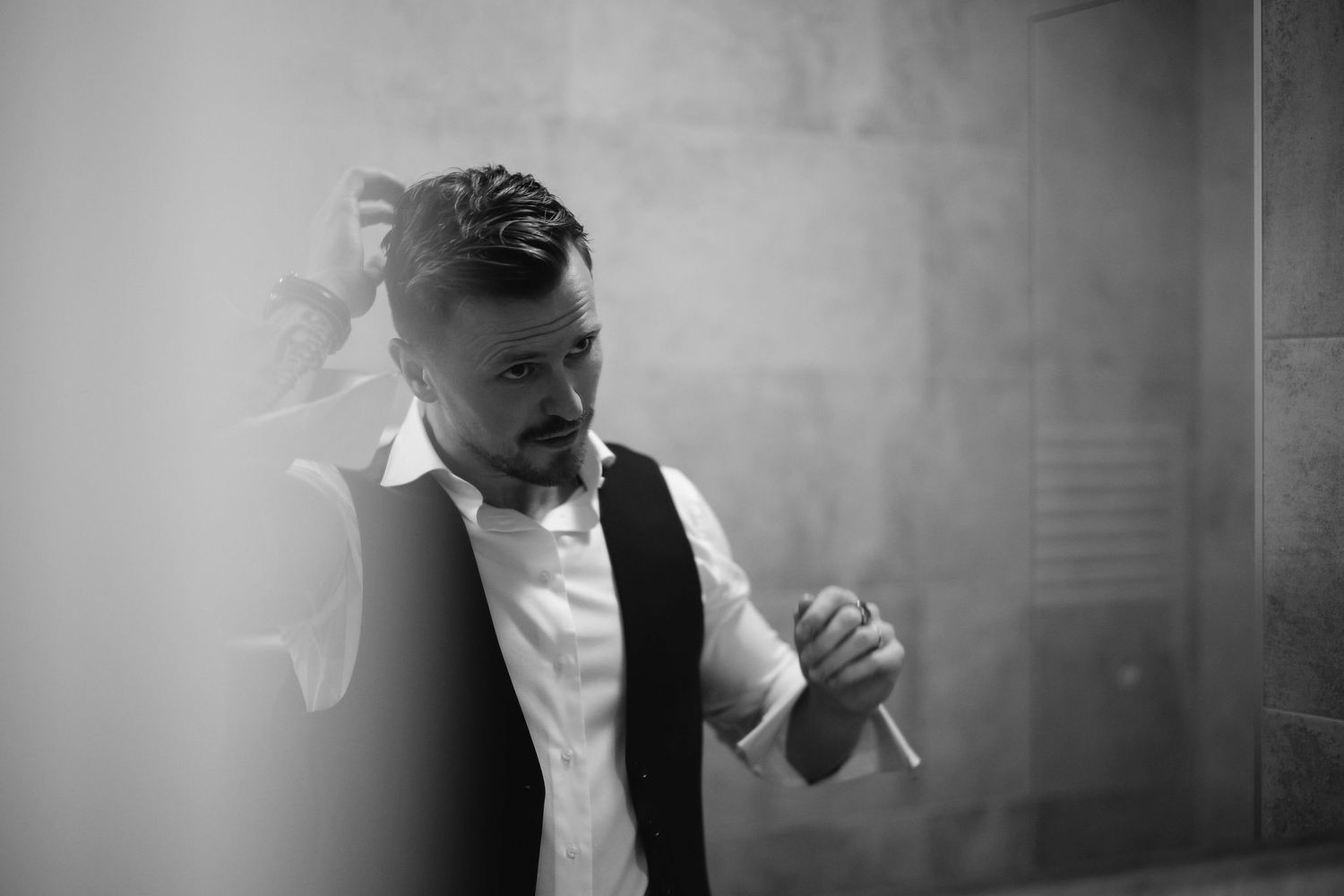 Artistic black and white portrait of a person dancing in formal attire.