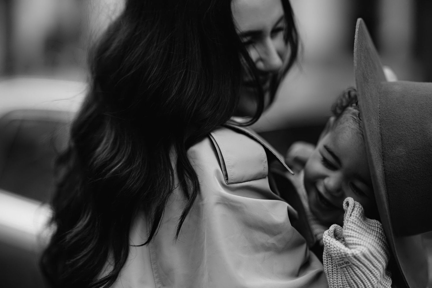 A tender black and white portrait of a parent and child sharing an intimate moment together.