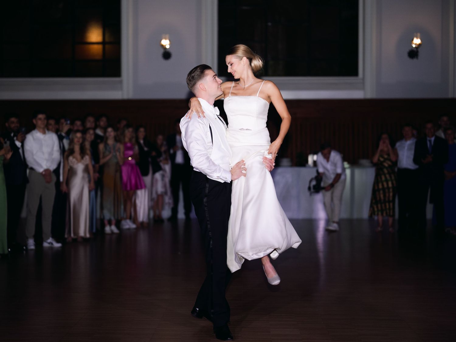 Elegant high-society couple sharing their wedding first dance at the luxurious Buda Castle Royal Riding Hall, surrounded by timeless glamour