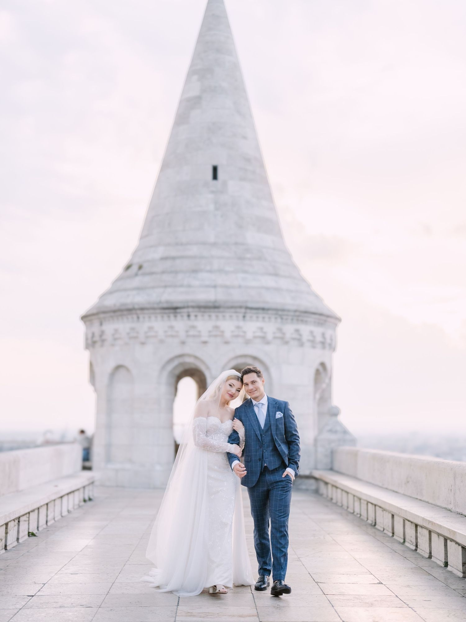 Captivating couple posing at sunrise on Fisherman’s Bastion in Budapest for a pre-wedding session, captured by Hang Pham Photography