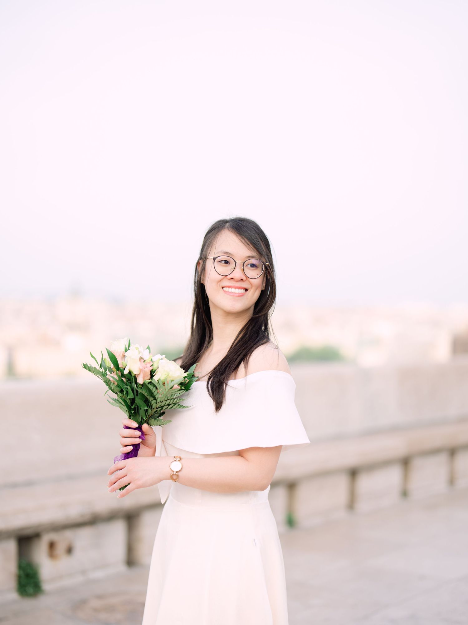 Charming bride posing during a scenic engagement shoot with breathtaking views of Budapest from Fisherman’s Bastion at golden hour