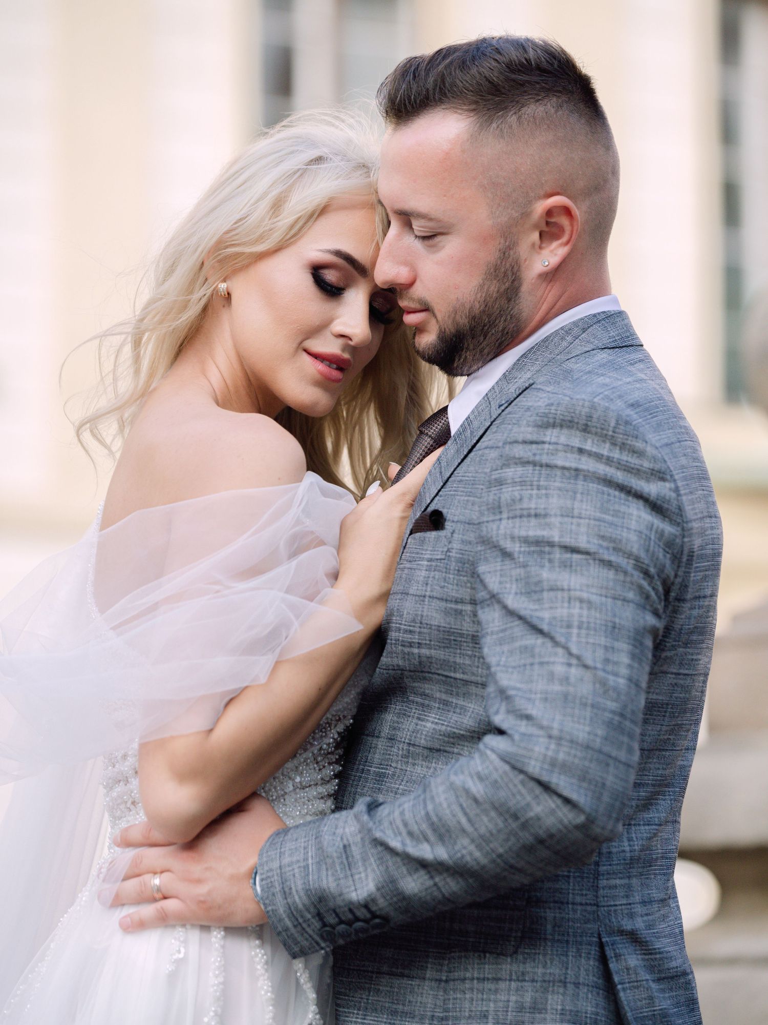 Dynamic couple posing at Prague Castle during a destination elopement, surrounded by historic architecture, captured by Hang Pham