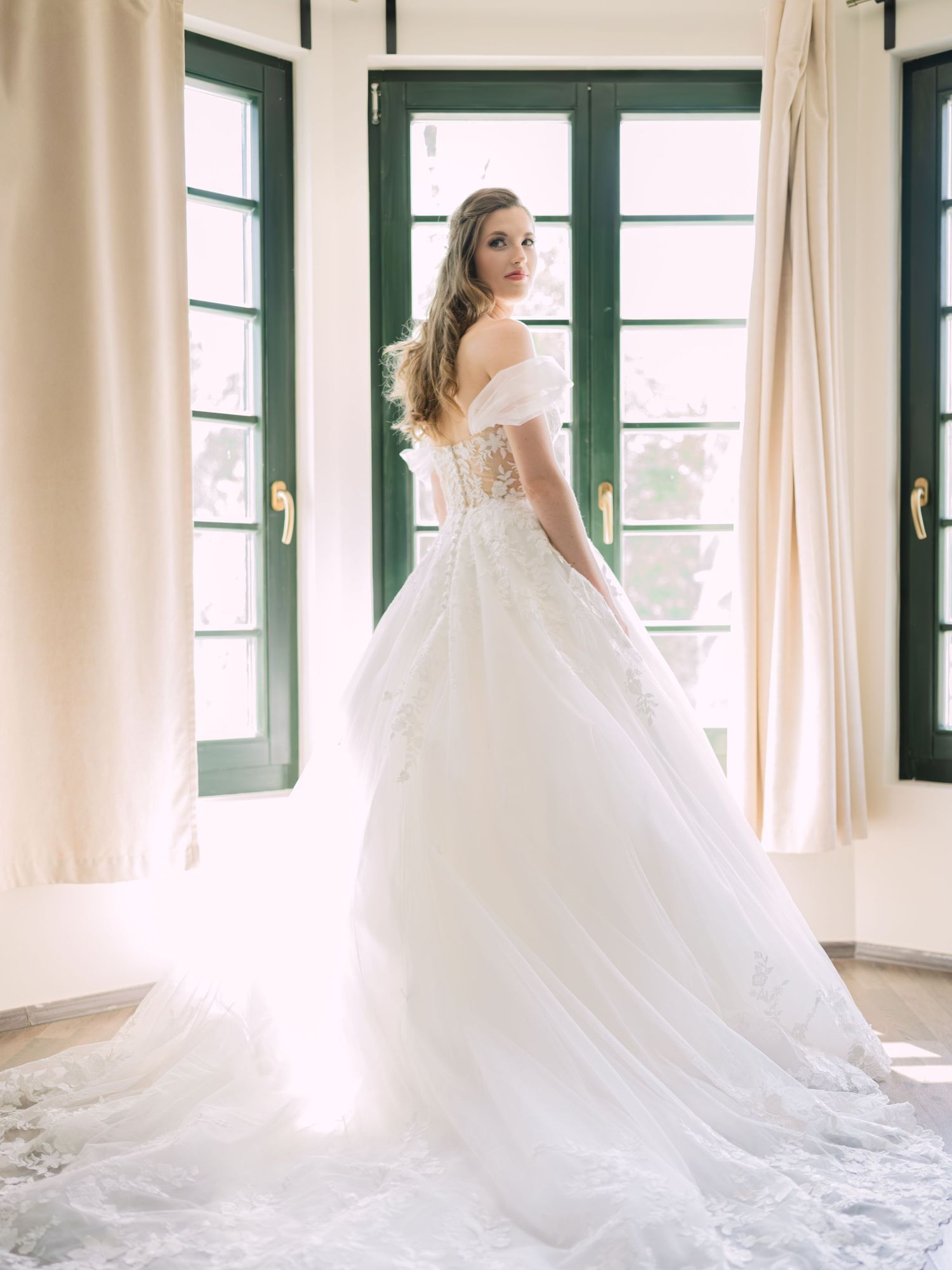 Cheerful bride posing elegantly for a stunning bridal portrait in Budapest, captured during an intimate wedding with timeless charm