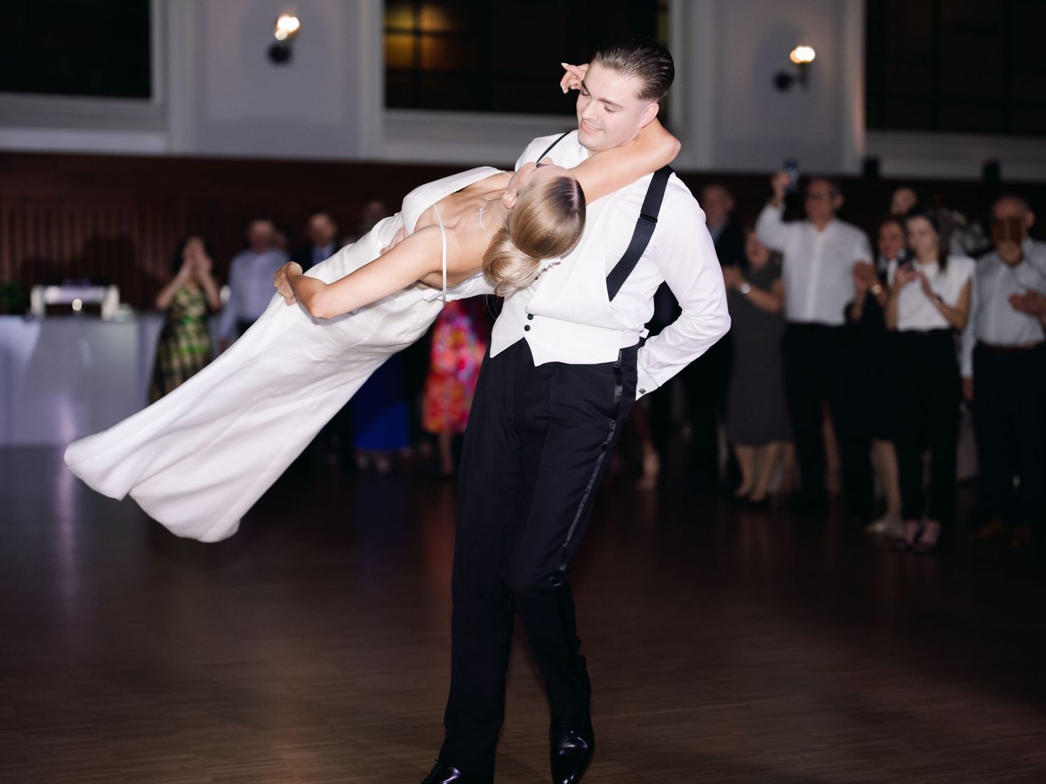 Elegant high-society couple sharing their wedding first dance at the luxurious Buda Castle Royal Riding Hall, surrounded by timeless glamour