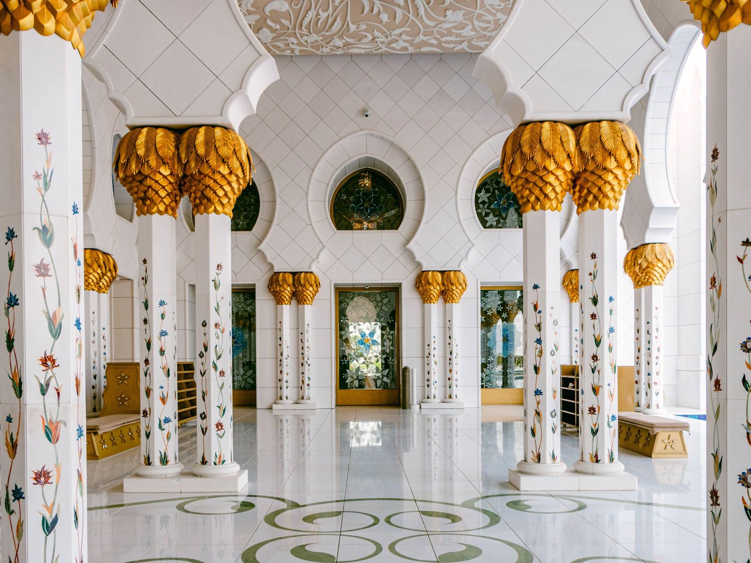 Elegant interior of Abu Dhabi Grand Mosque showcasing intricate architecture, grand halls, and serene ambiance