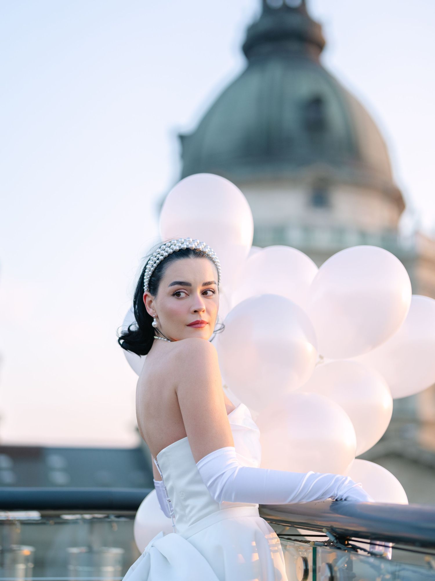 Elegant bride in a Rami Wedding Dress posing at High Note Skybar Budapest during a destination wedding editorial, captured by Hang Pham