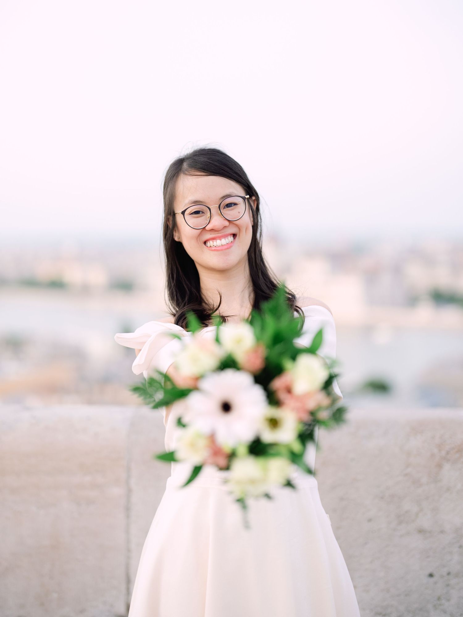 Charming bride posing during a scenic engagement shoot with breathtaking views of Budapest from Fisherman’s Bastion at golden hour