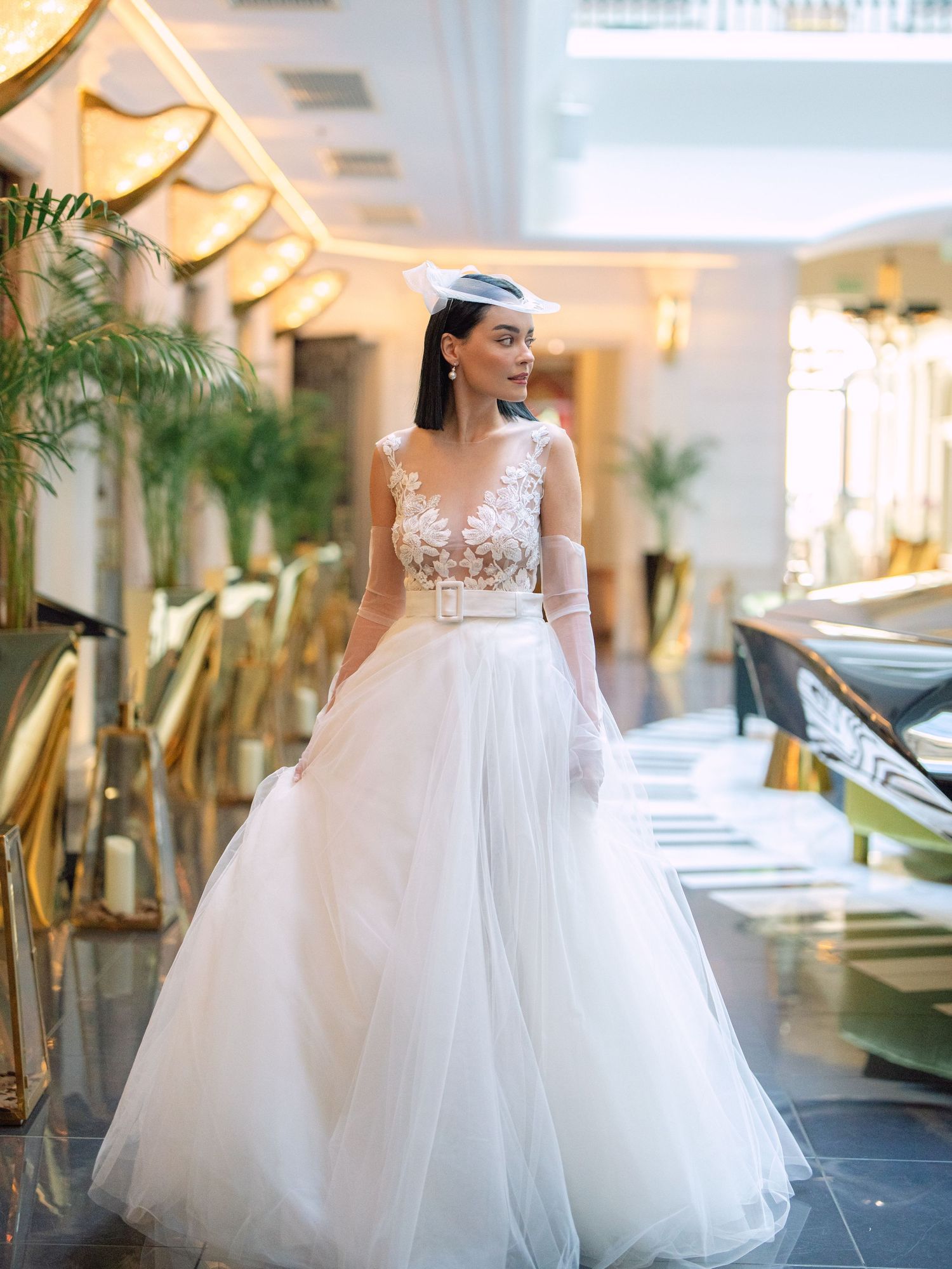 Elegant bride in a Nagy Agota wedding dress posing at Aria Hotel Budapest during a destination wedding editorial, captured by Hang Pham
