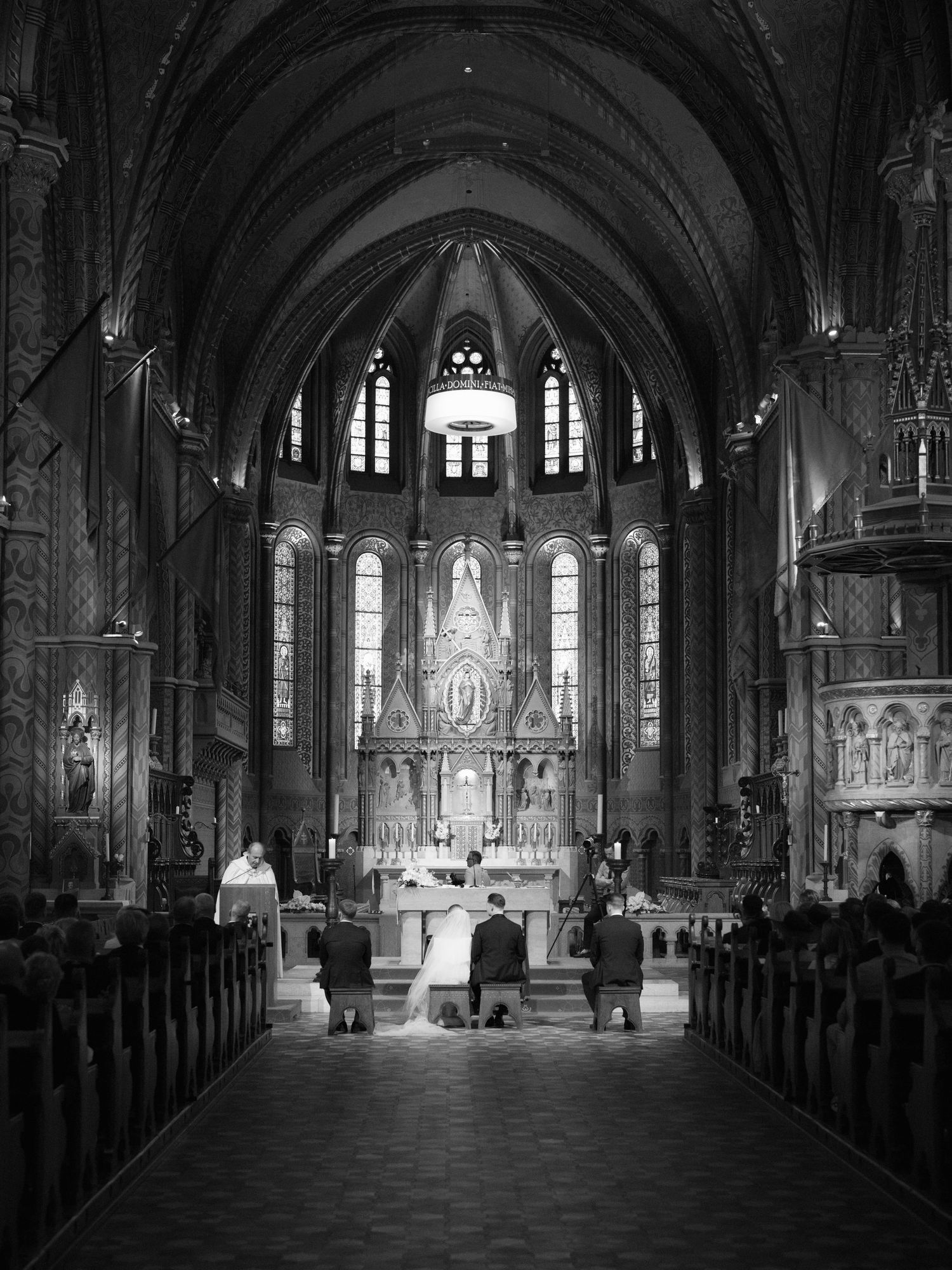 High-end couple during their wedding ceremony at St. Matthias Church in Budapest’s Buda Castle, celebrating in an elegant destination venue