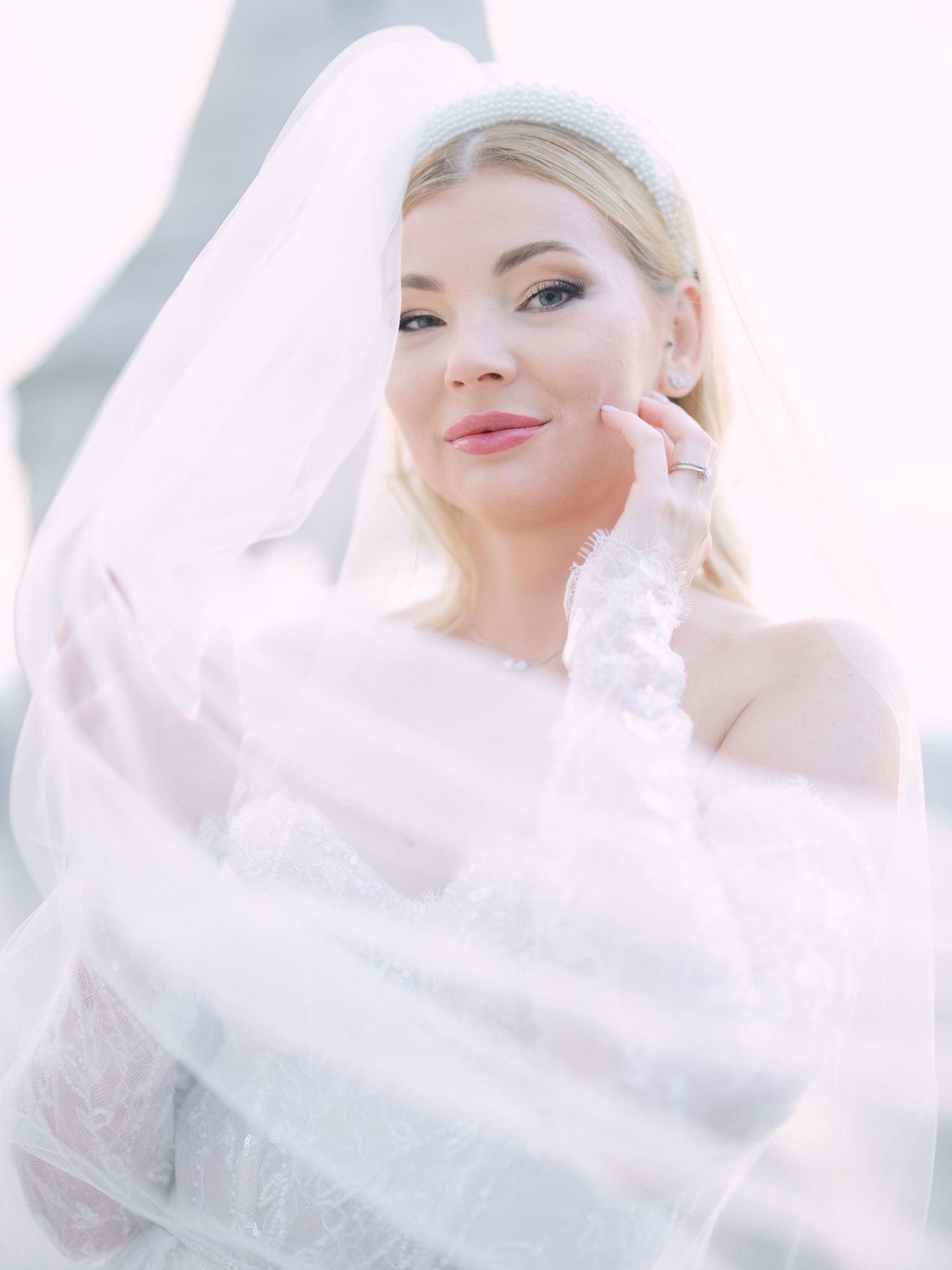 Captivating bride in a La Mariée dress posing at sunrise on Fisherman’s Bastion in Budapest during a pre-wedding session by Hang Pham