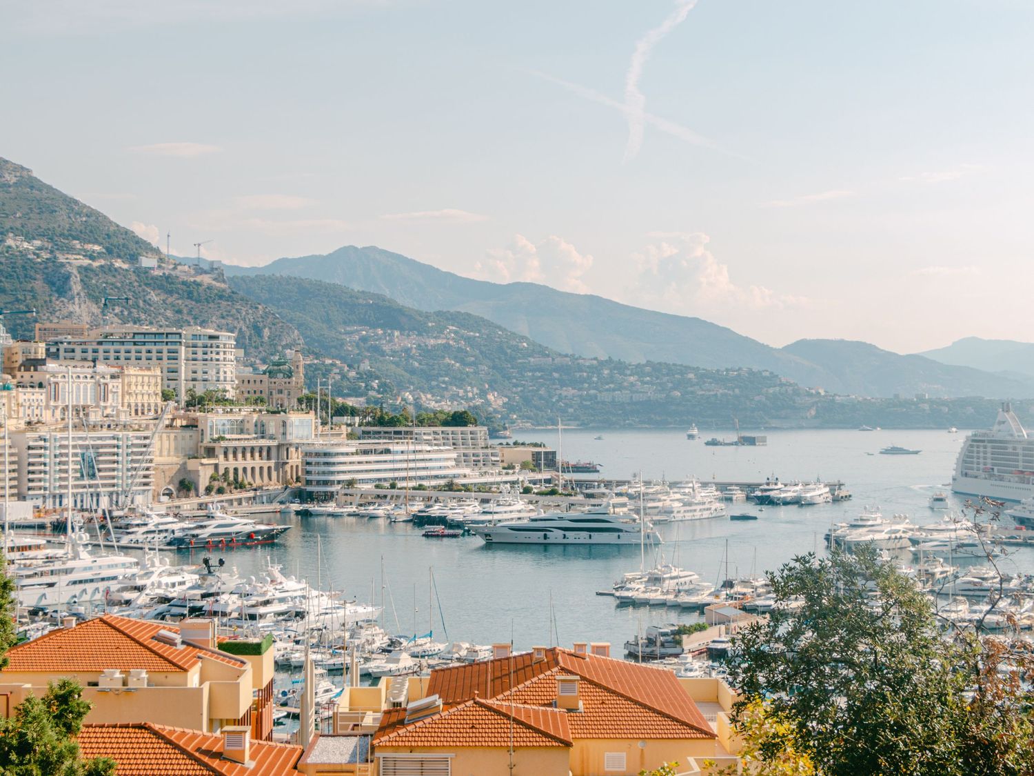 Romantic view of Monaco’s sunlit coastline, featuring luxury yachts and iconic architecture, a perfect destination for weddings or getaways